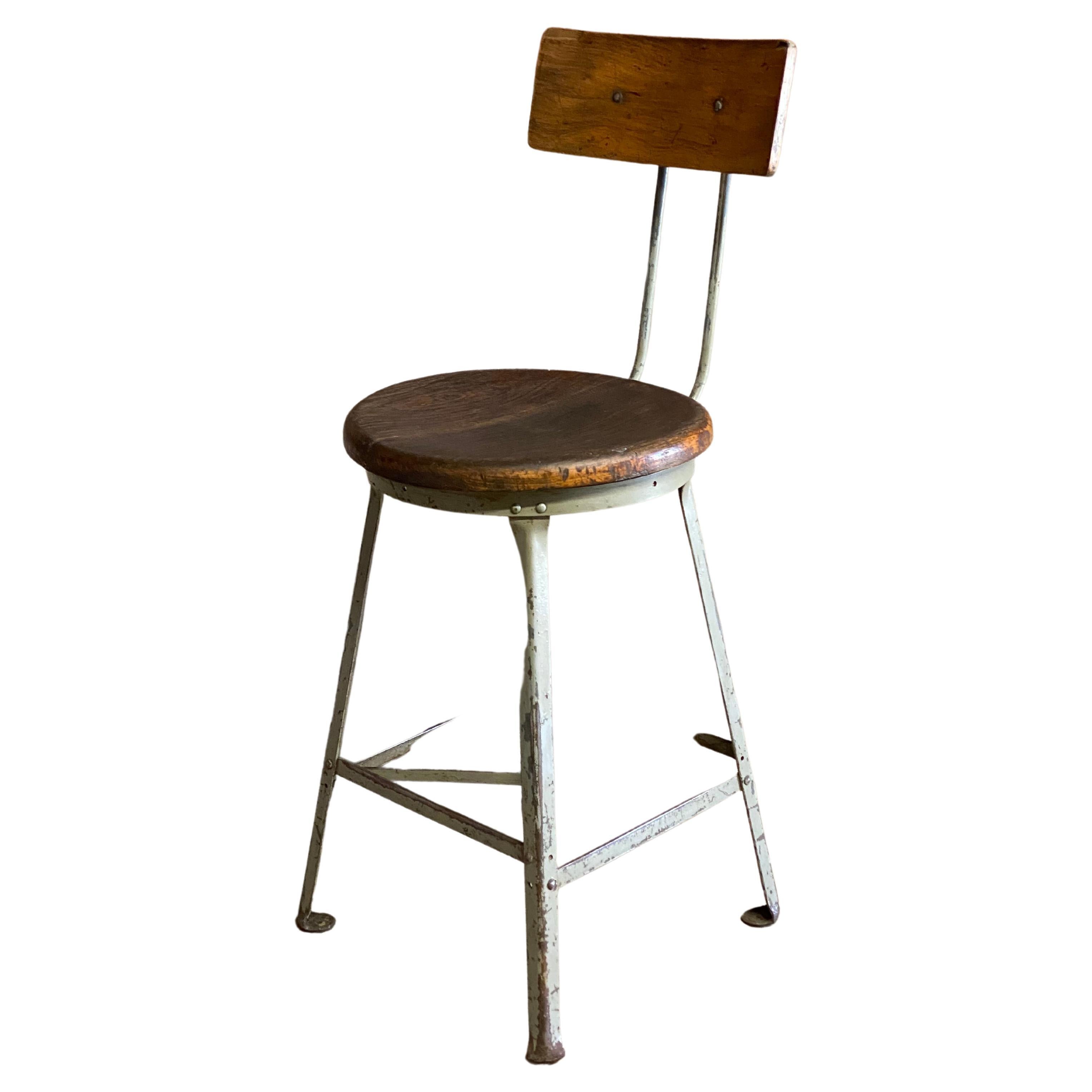 Angle Steel Stool Inc. adjustable industrial stool. Steel frame construction with solid wood (oak) seat and contoured back. Adjustable back height and depth. The seat height is stationary and does not swivel. Great for the kitchen island or a fine