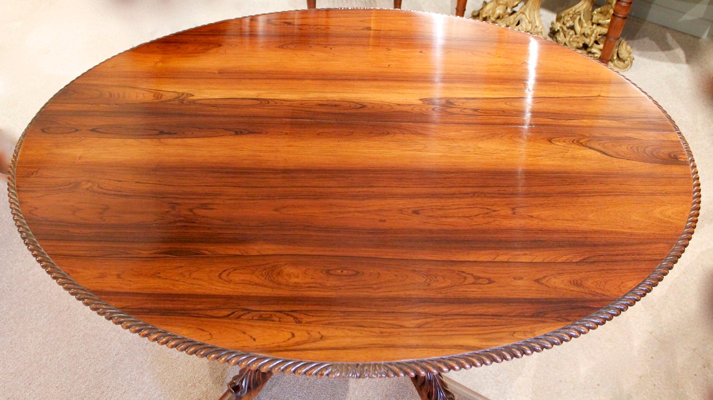A remarkable and stylish tilt top table of solid rosewood timber. The extraordinarily fine figured top is edged with gadroon carving. The pedestal is composed of a boldly carved spiral twist terminating in four deeply carved acanthus topped