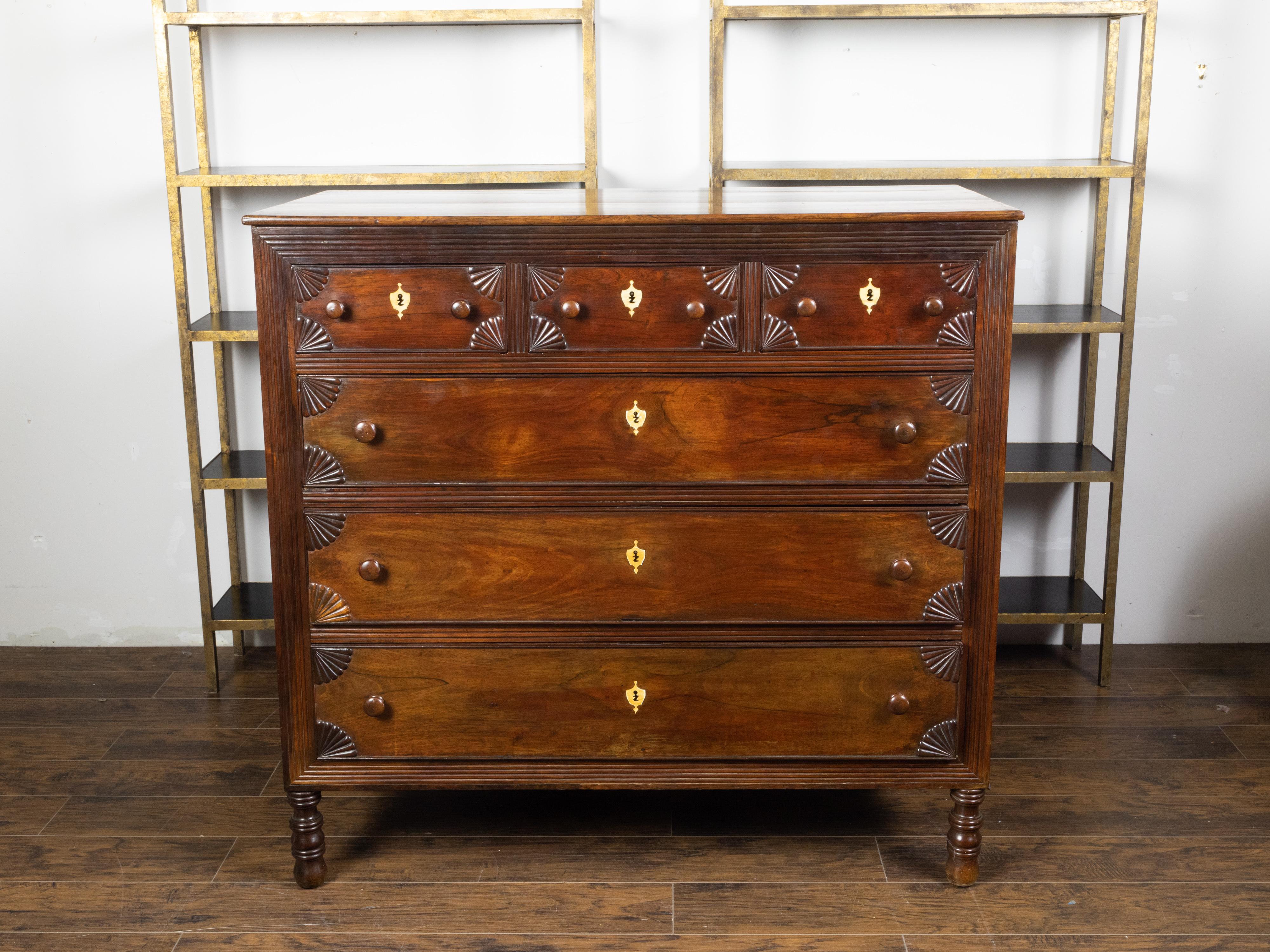 An Anglo-Indian six-drawer chest from the early 19th century with radiating fan motifs and bone inlay. Created during the early years of the 19th century, this chest features a rectangular top sitting above a perfectly organized façade adorned with