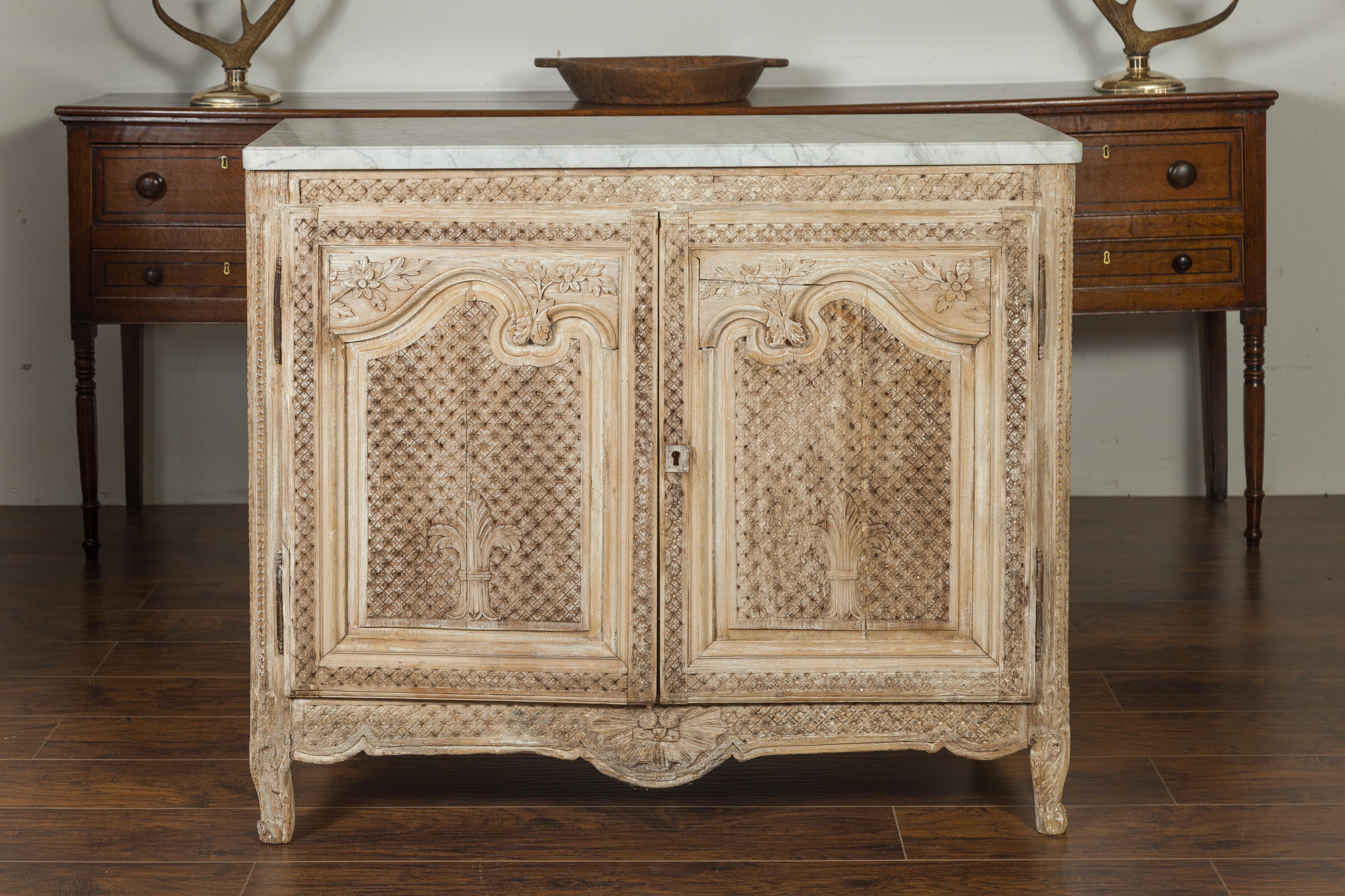 An Anglo-Indian stripped and bleached pine buffet from the early 19th century, with cross-hatch and floral motifs, and white veined marble top. Created during the first quarter of the 19th century, this stripped and bleached pine buffet features a