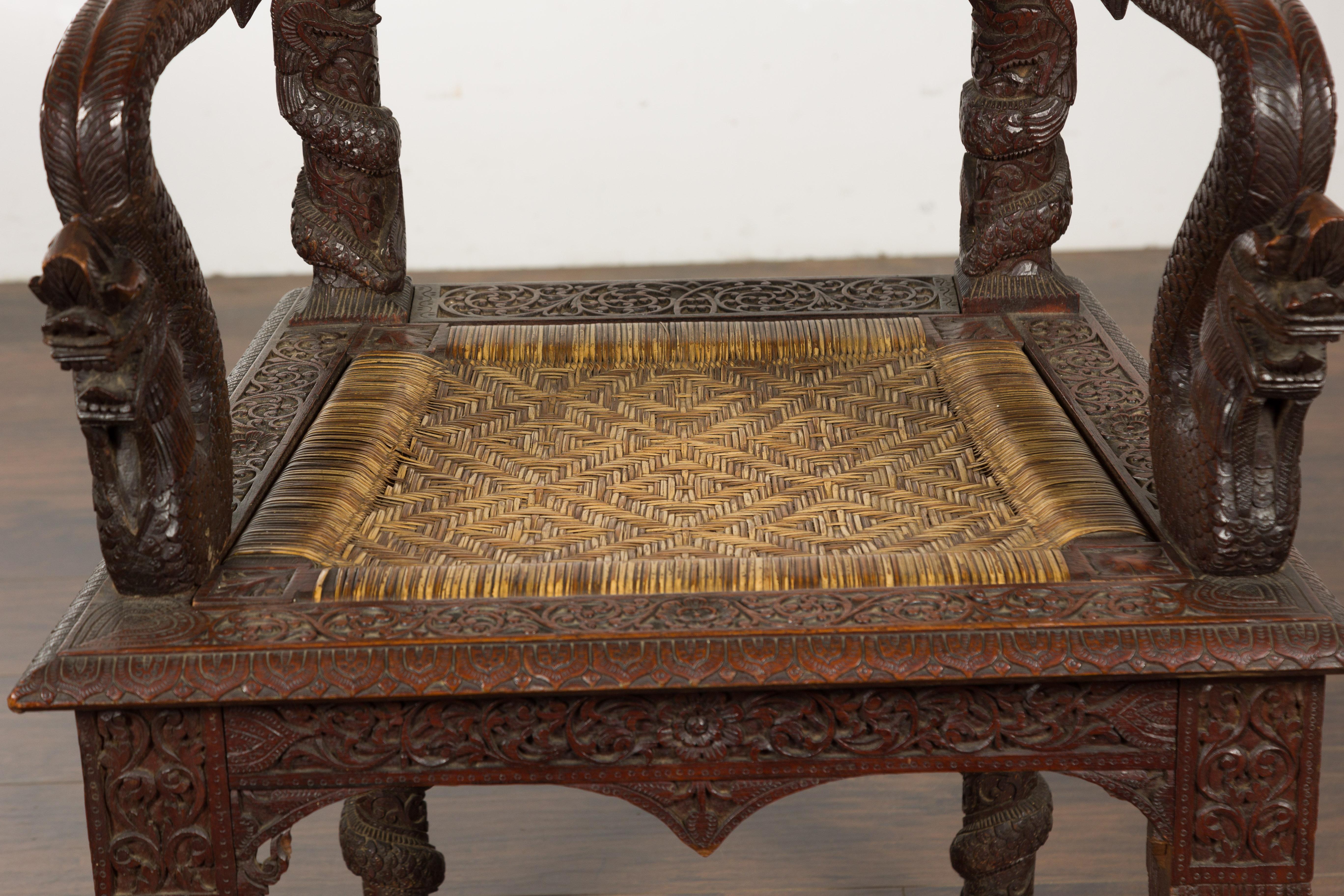 Anglo-Indian 1900 Armchair with Carved Back, Mythical Creatures and Woven Rattan In Good Condition For Sale In Atlanta, GA