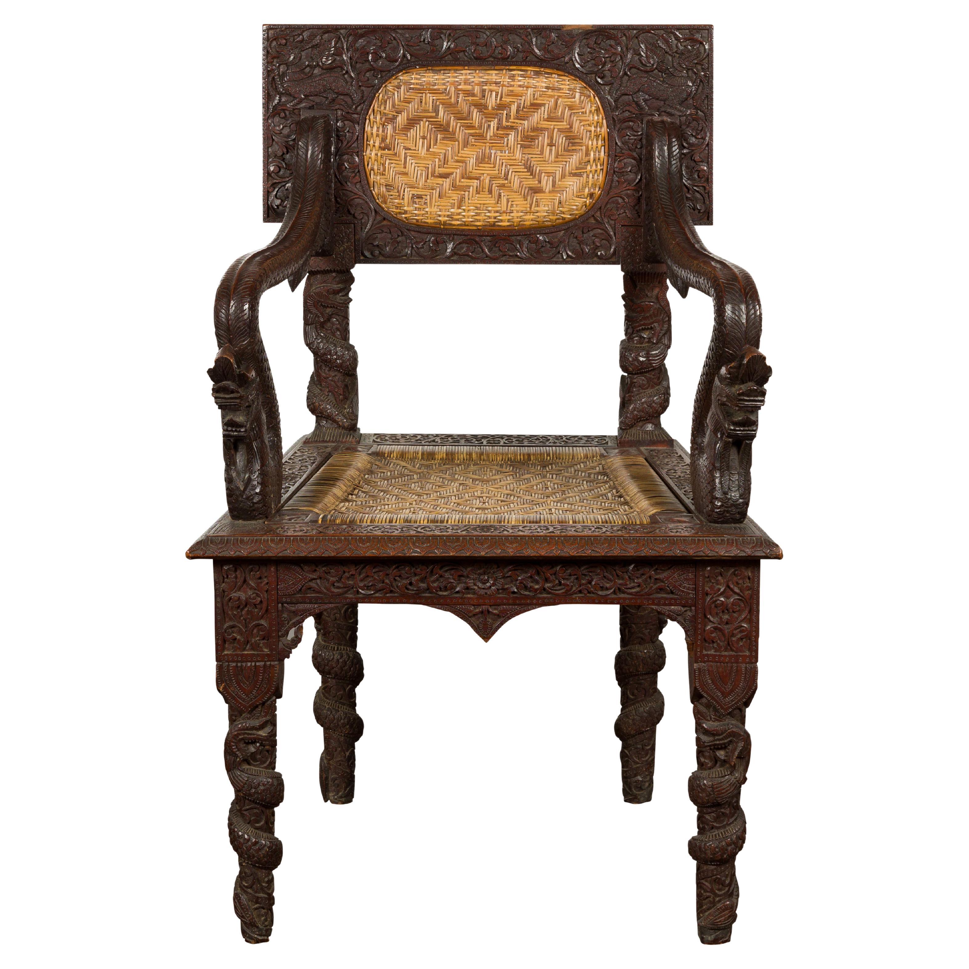 Anglo-Indian 1900 Armchair with Carved Back, Mythical Creatures and Woven Rattan