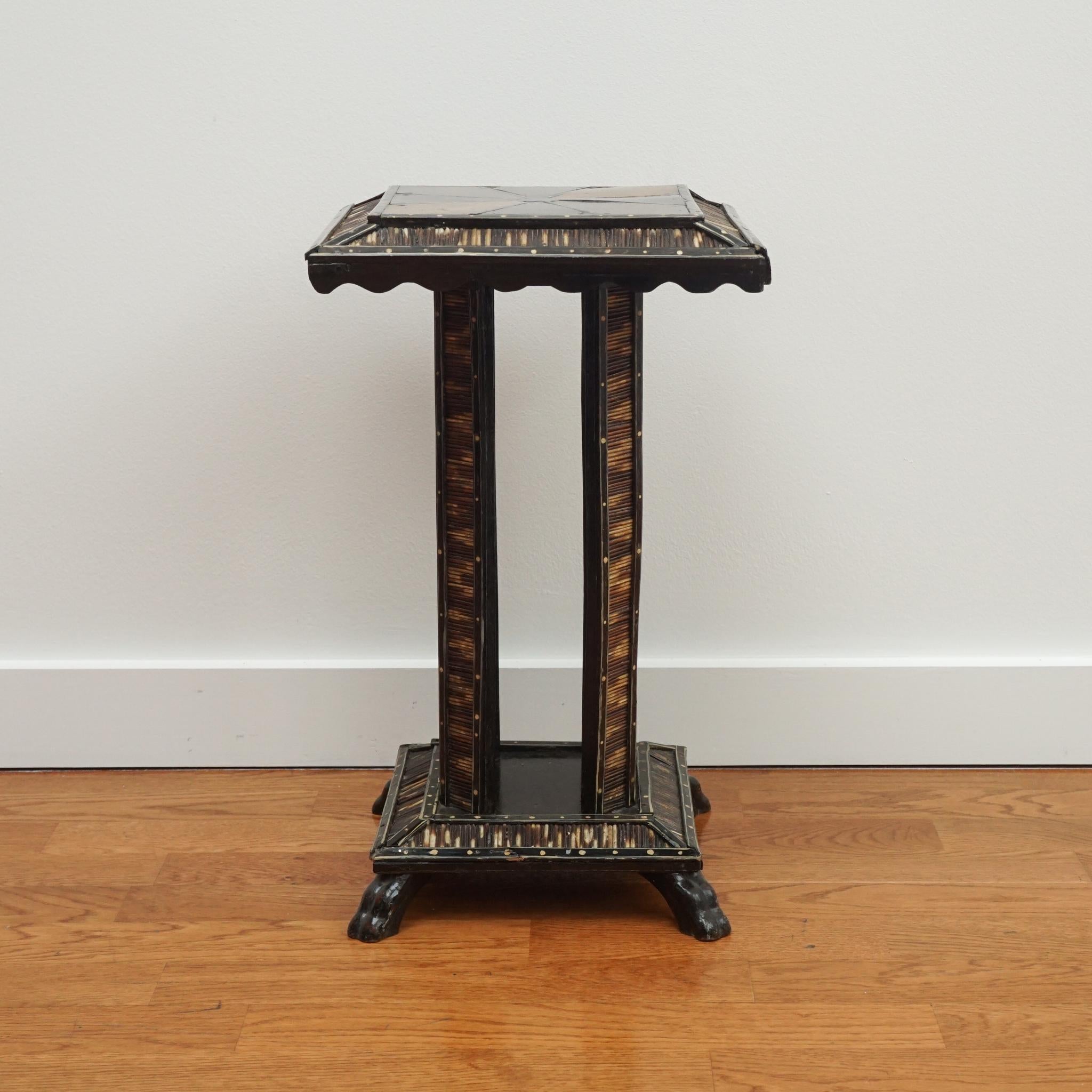 This small-scale antique accent table is from the Sandra Long Collection of Anglo-Indian treasures. Combining ebony wood, ivory dots and tropical wood inlays, the square top table is detailed top to bottom in porcupine quills. The table is newly