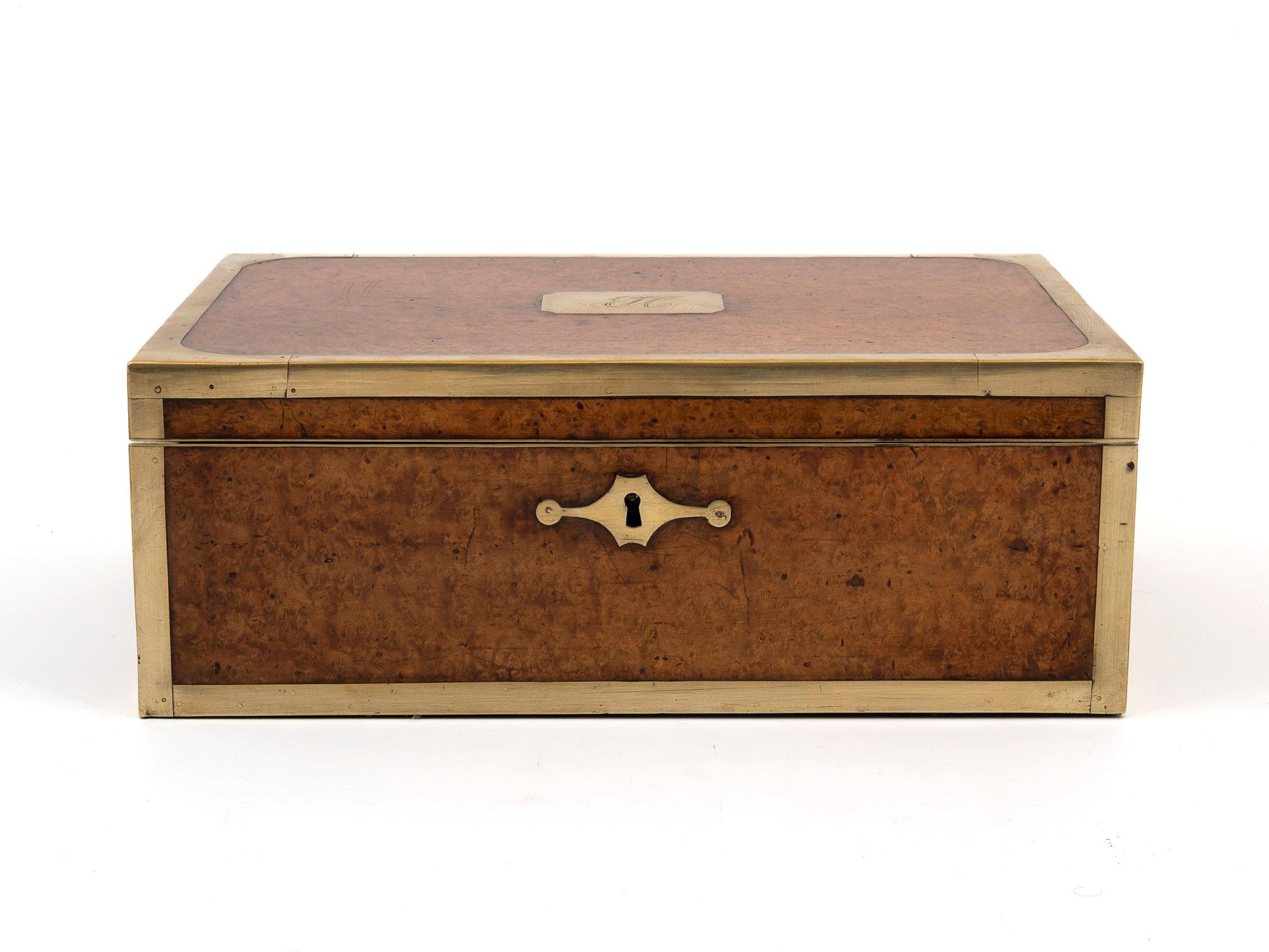 Brass Bounded

From our Writing Box collection, we are pleased to offer this Anglo Indian Amboyna Campaign Writing Box. The Writing Box of slim rectangular form made from Amboyna with thick brass banding around the perimeter. The box with a brass