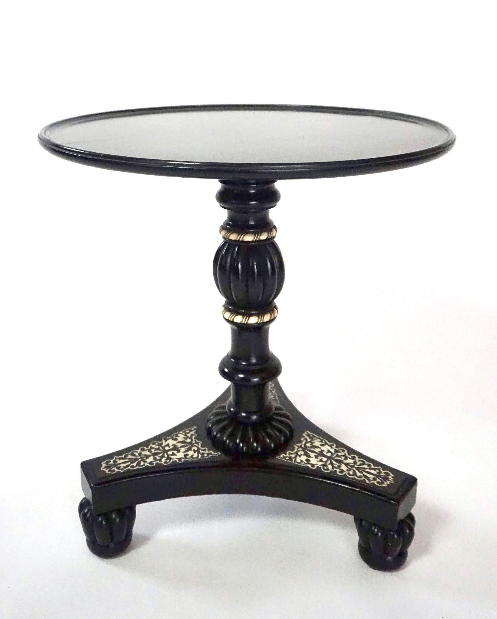A rare and wonderful circa 1840 Anglo-Indian petite low table in bone-inlaid and mounted ebony, the round dished top on carved and turned pedestal joining concave platform base on reeded tapered feet. Perfect scale for use beside a club chair.