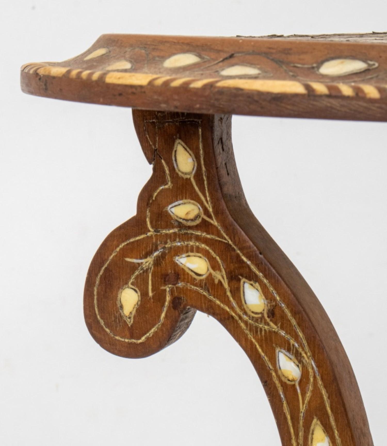 
The dimensions for the Anglo-Indian Bone Inlaid Occasional Table, with a circular top on shaped volute legs conjoined by a finial, allover inlaid with bone in floral patterns, are approximately:

Height: 27.5 inches
Diameter: 17 inches



