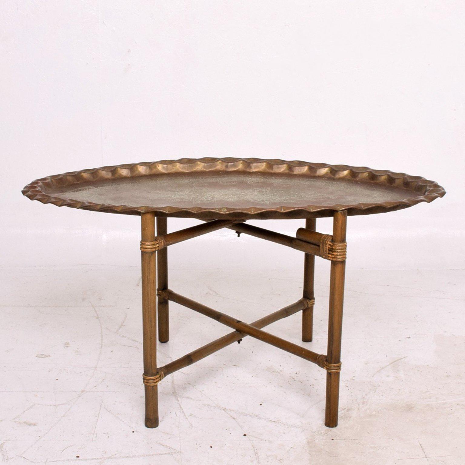 For your consideration a vintage coffee table made of bamboo base and scalloped brass tabletop in oval shape. 

Original vintage patina. Great character. 
19 1/4