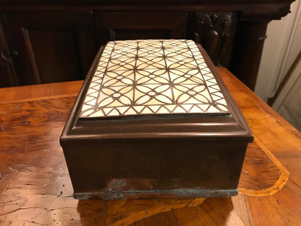 A handsome and unusual brass strongbox with intricate patterned polished bone inlay on the top. The inside with a till, the lid of the till decorated with incised designs. This box could be polished but I prefer the patina of age. Some verdigris
