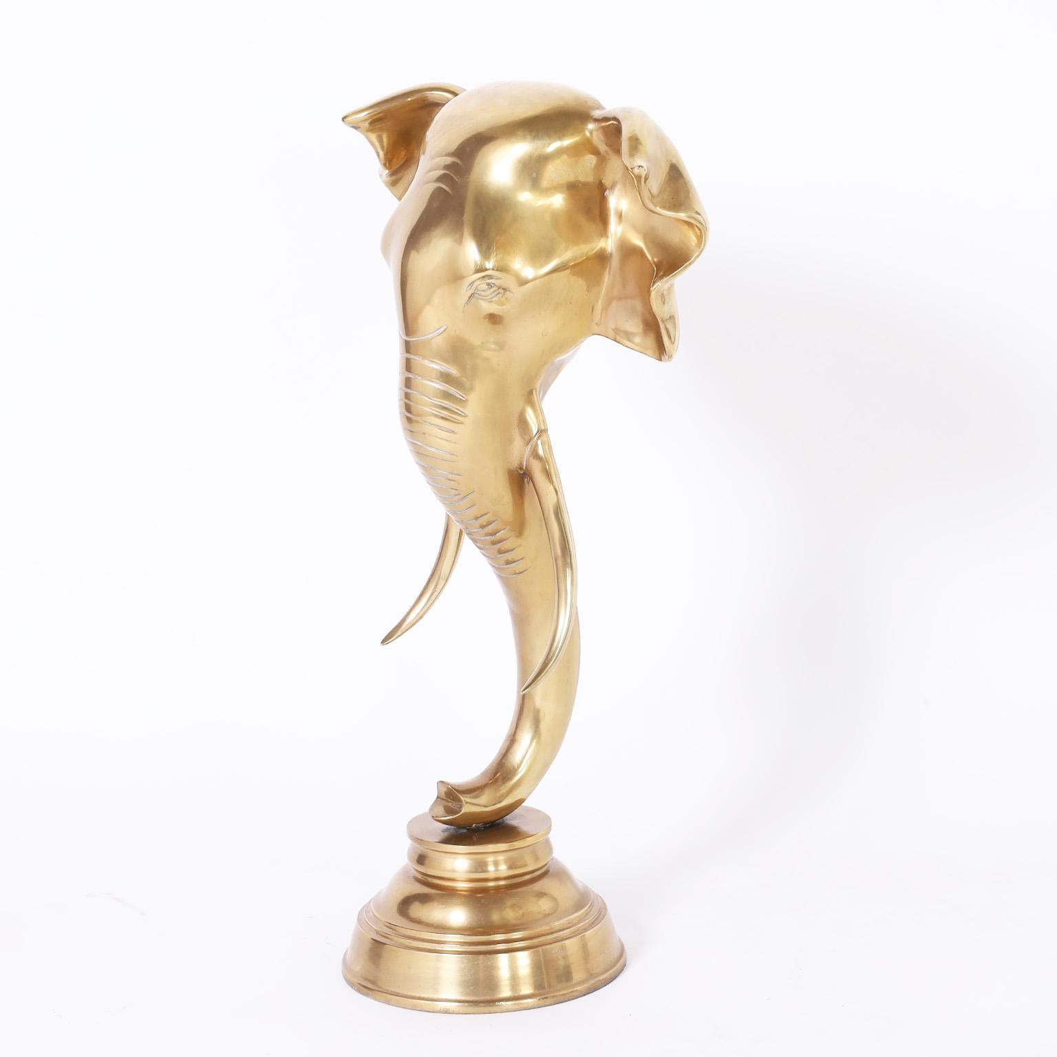 Standout Anglo Indian cast brass elephant head sculpture presented on a turned brass stand. Hand polished and lacquered for easy care.
