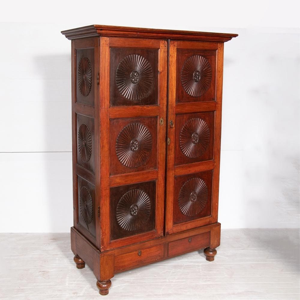 An Anglo India cabinet from Kerala, South West India made in Burma teak with rosewood sunburst pannels.