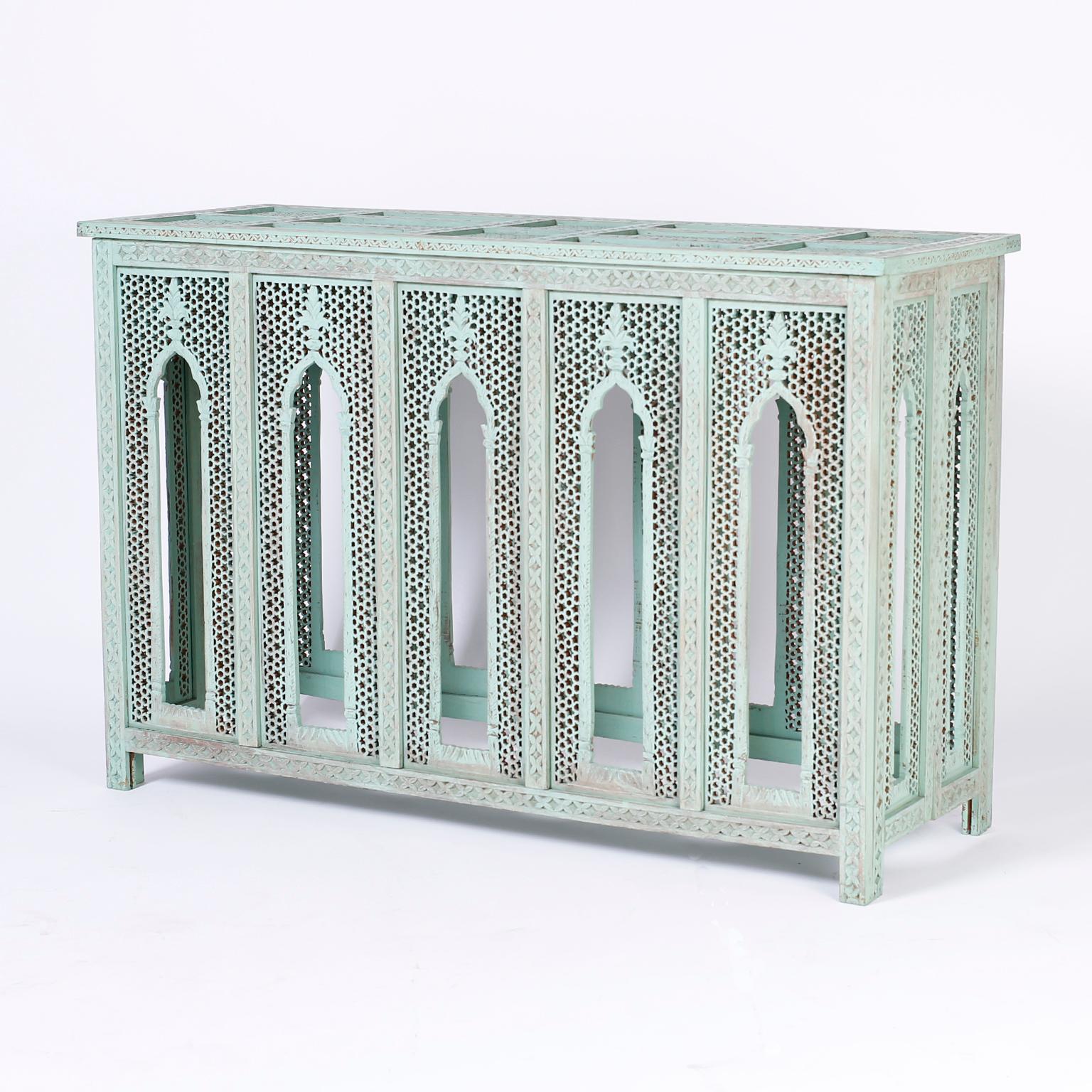 Lofty Anglo-Indian vintage console crafted in hard wood with a weathered sea foam finish on architecturally intriguing Moorish style arches, inside carved trellis panels on the top and all four sides.