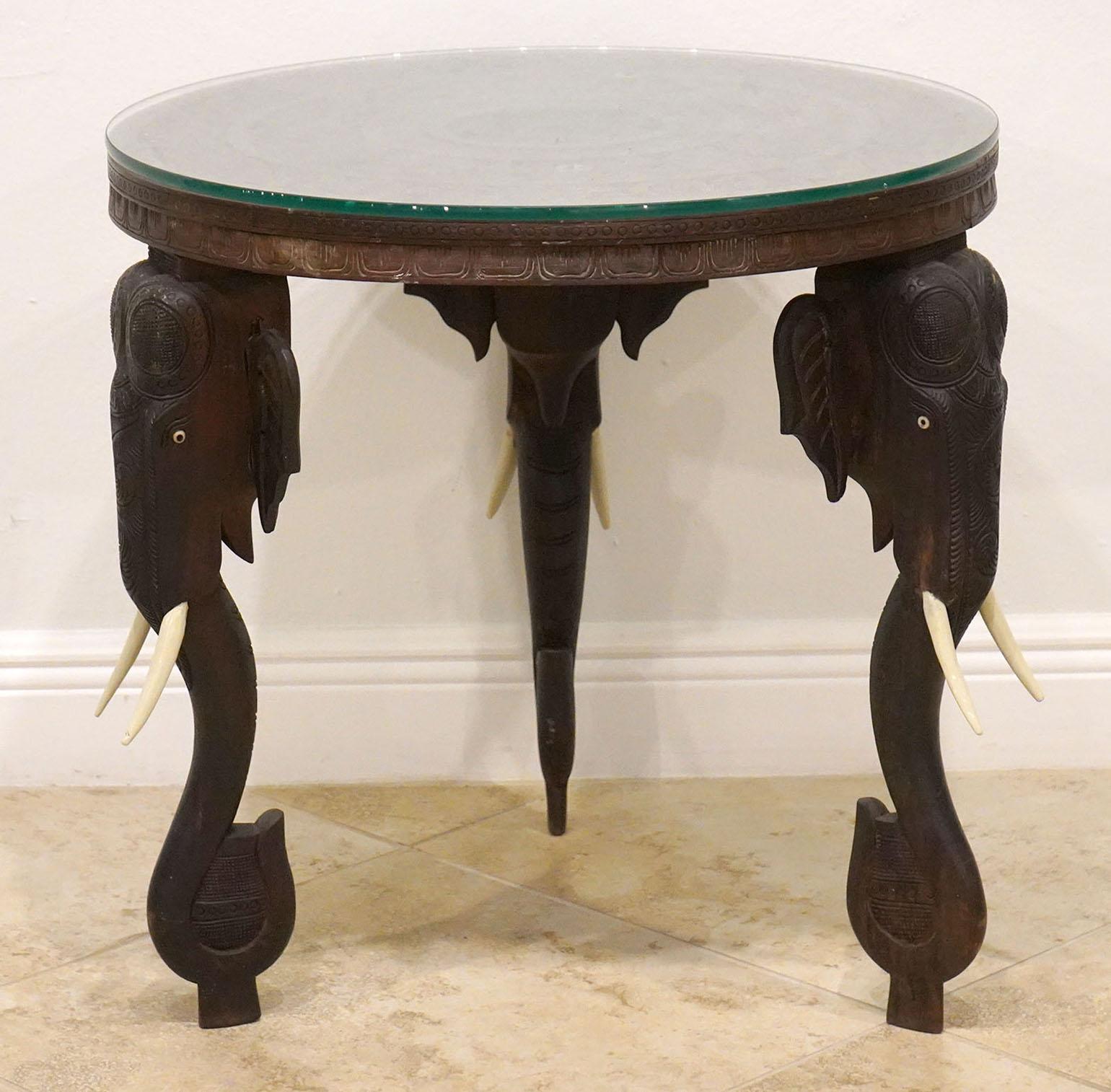 Anglo Indian carved round table with Elephant leg supports. Late 19th Century With Carved floral design top. Glass top can be removed.