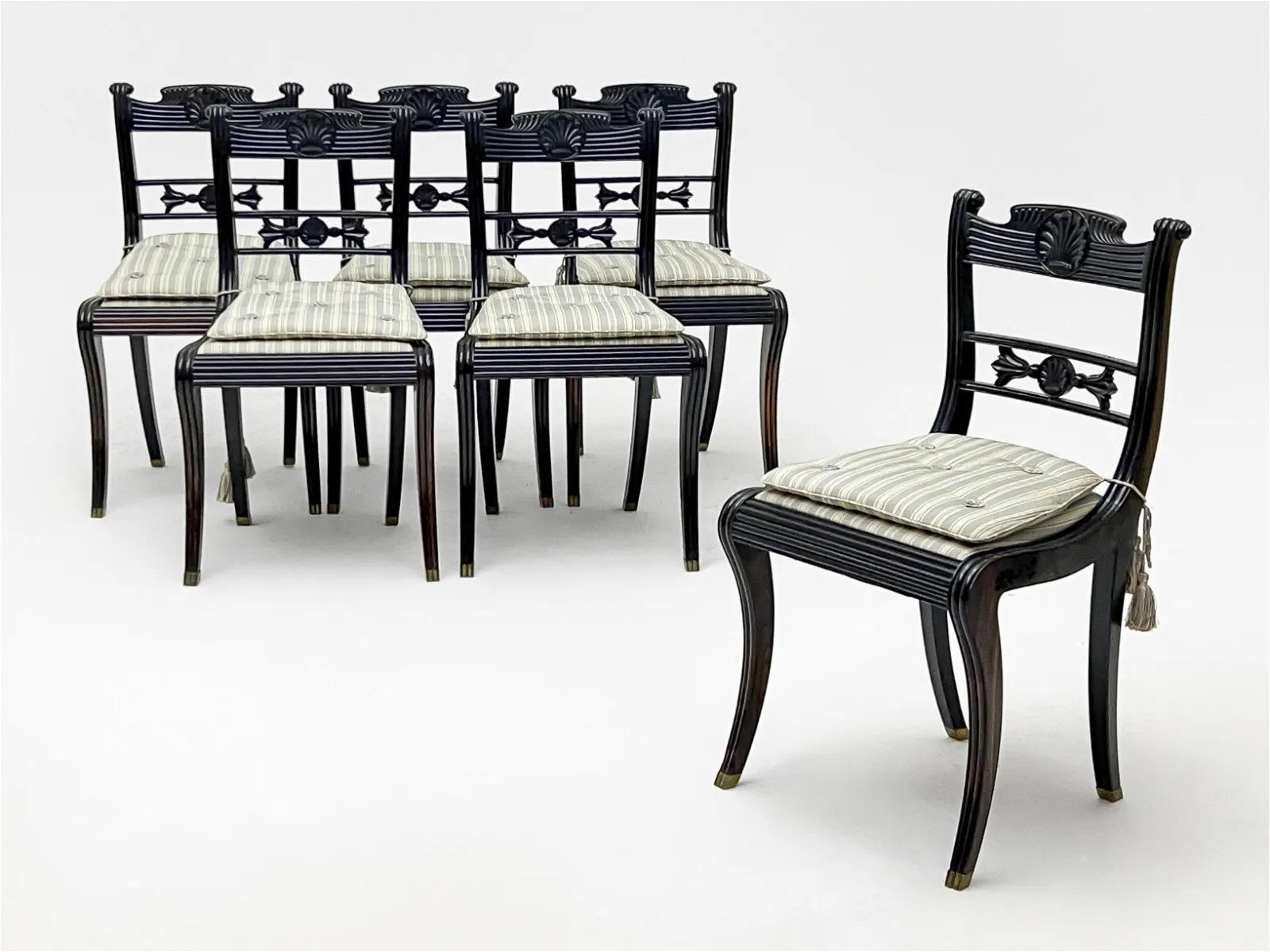 A rare and exquisite set of circa 1830 Anglo-Indian, Anglo-Ceylonese, or Sri Lankan Galle District manufactured carved solid ebony dining chairs of neoclassical English regency klismos form, the gadrooned and reeded crestrails having central