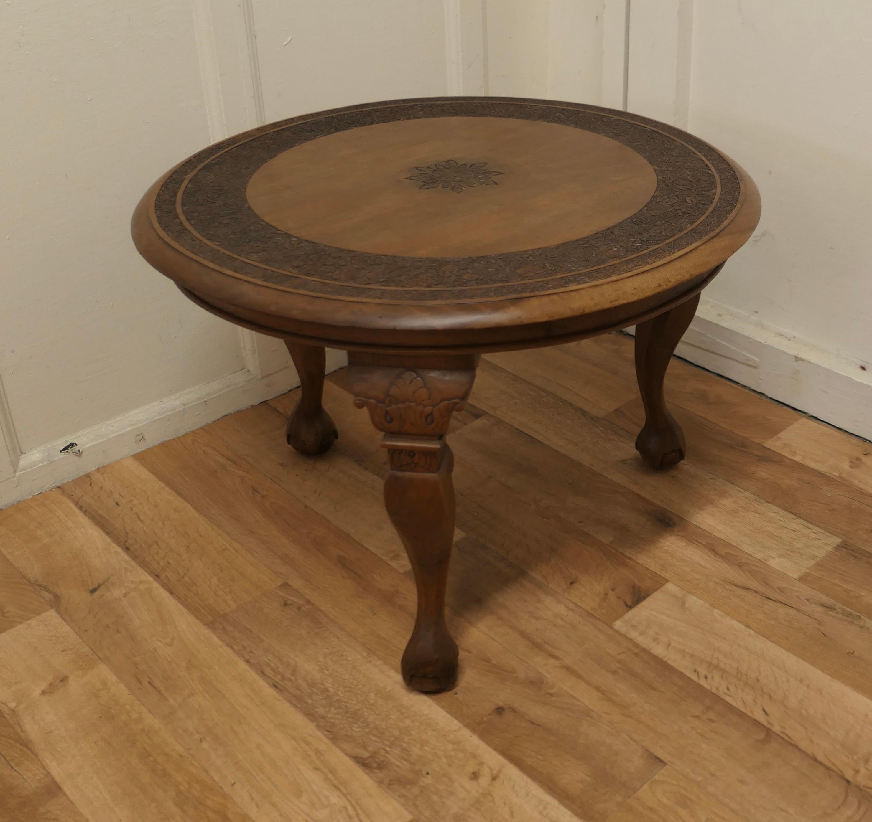 Anglo Indian carved teak occasional table or coffee table.

This is a very attractive piece and skilfully carved, a round Coffee Table which is set on pad foot cabriole legs
The table is in very good condition and has a smooth patina
The table