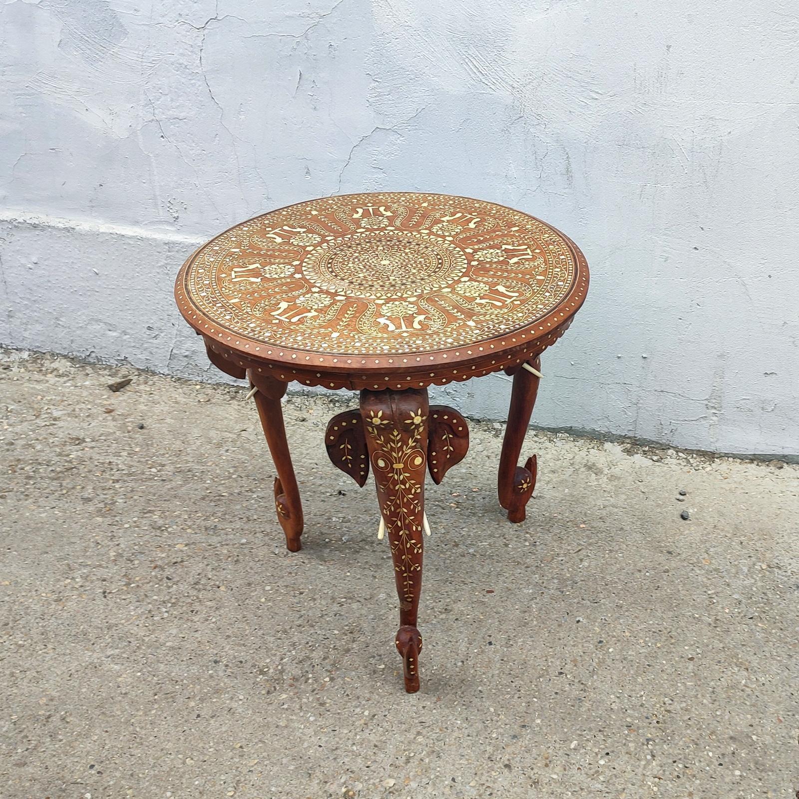 Anglo-Indian Mughal Teak Inlaid Round Side Table.
A refined and elegant round side table that is hand-carved with bone inlaid and has an elaborate peacock and tree design.
With bone inlaid figurative details, resting on the three supporting legs,