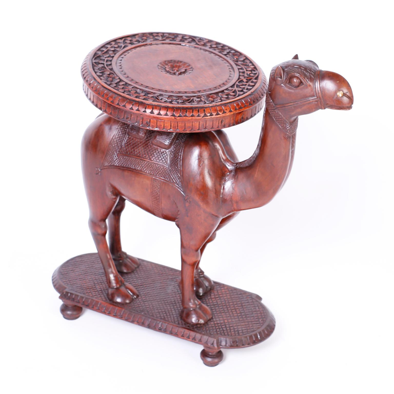 Anglo-Indian camel drinks or plant stand crafted in mahogany with a round tray carved with floral and geometric designs.