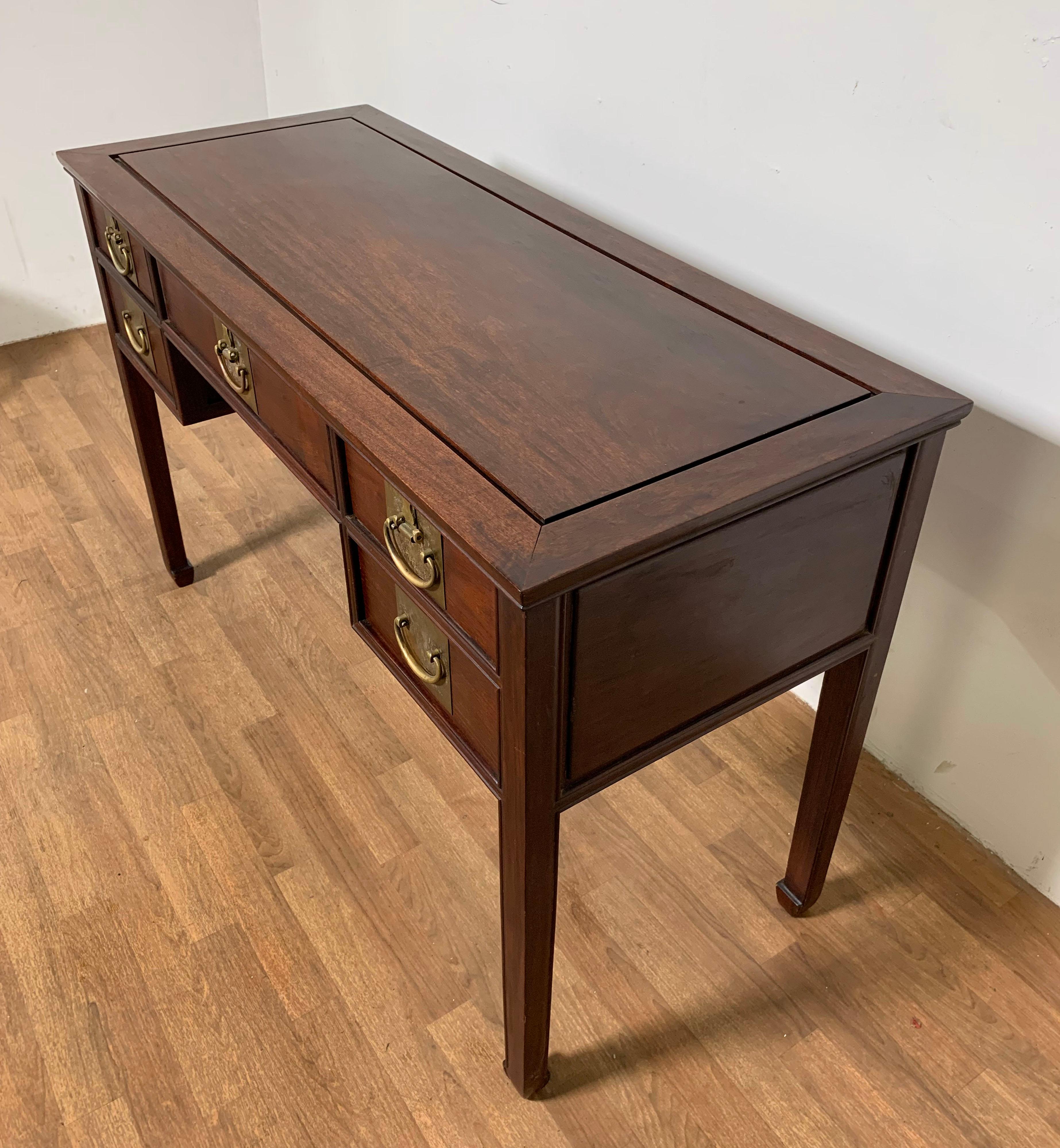 A fine campaign style writing desk in the British Colonial manner dating to the mid 20th century.