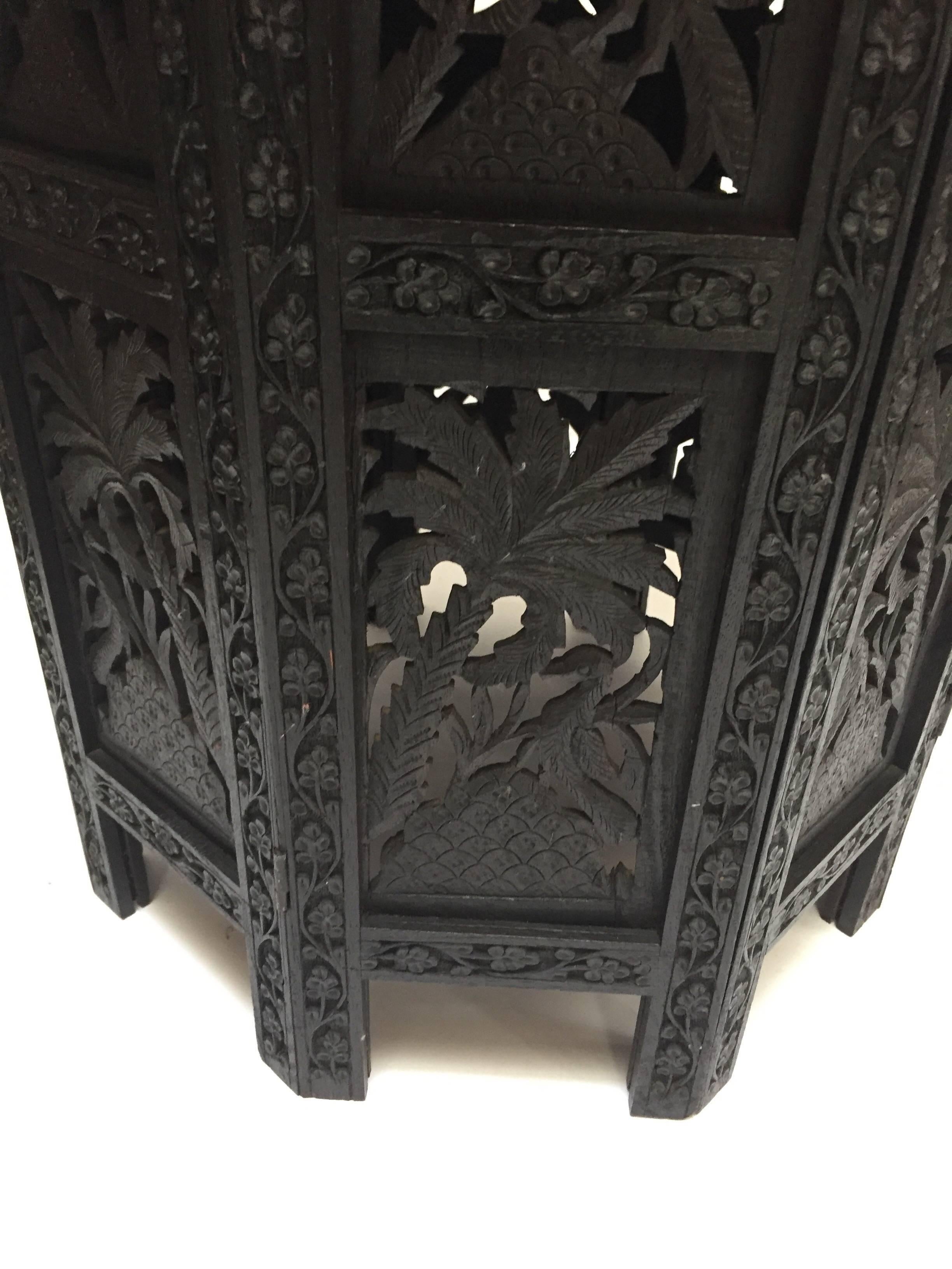 Anglo-Indian black ebonized highly decorative and hard to find finely hand carved and pierced with prolific foliage and wild life design.
Fine quality exotic Anglo-Indian pierced hand-carved octagonal table.
The top features an round panel with an