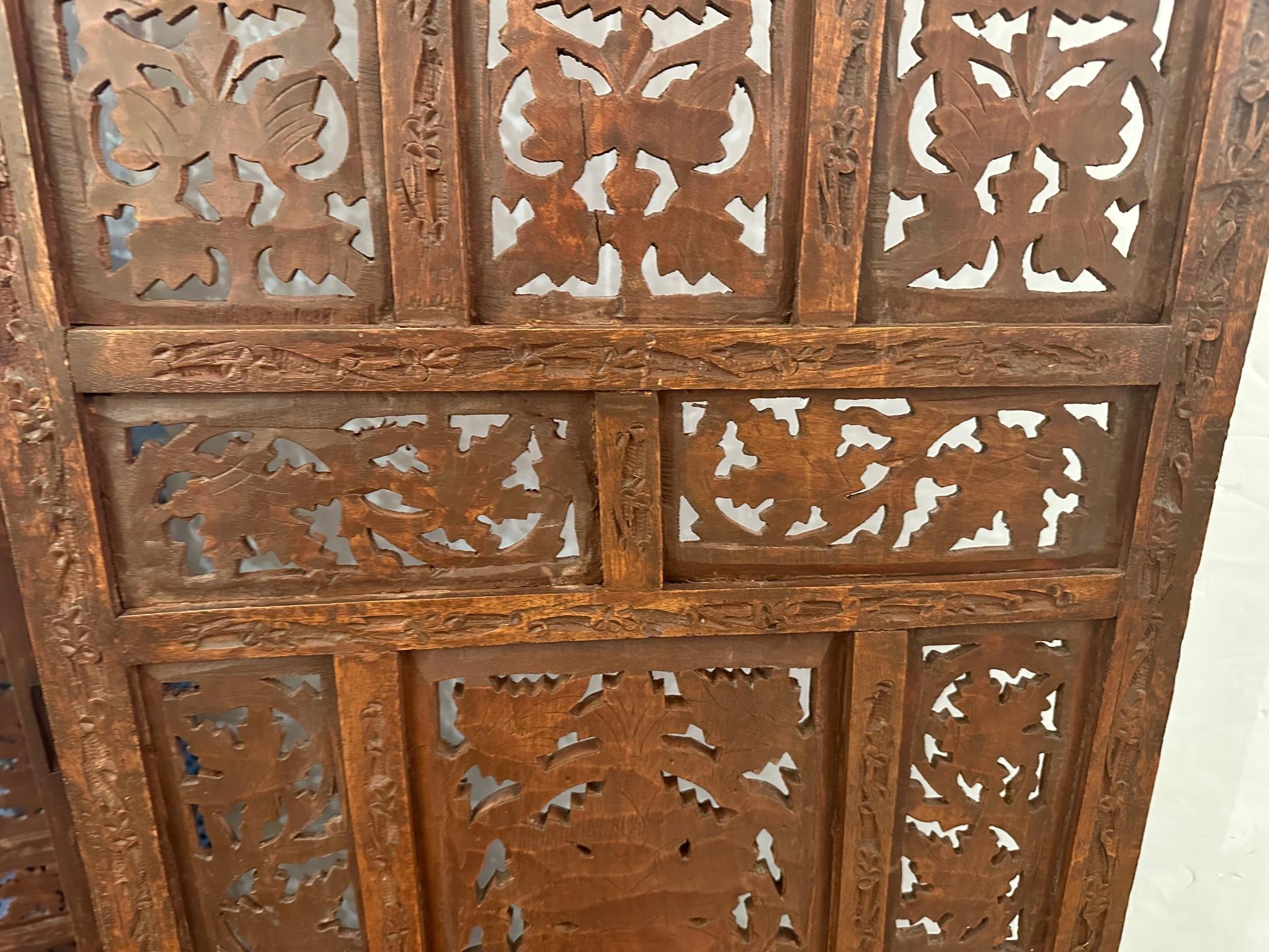 Classic hand carved wood 4 panel screen made in India with intricate design.