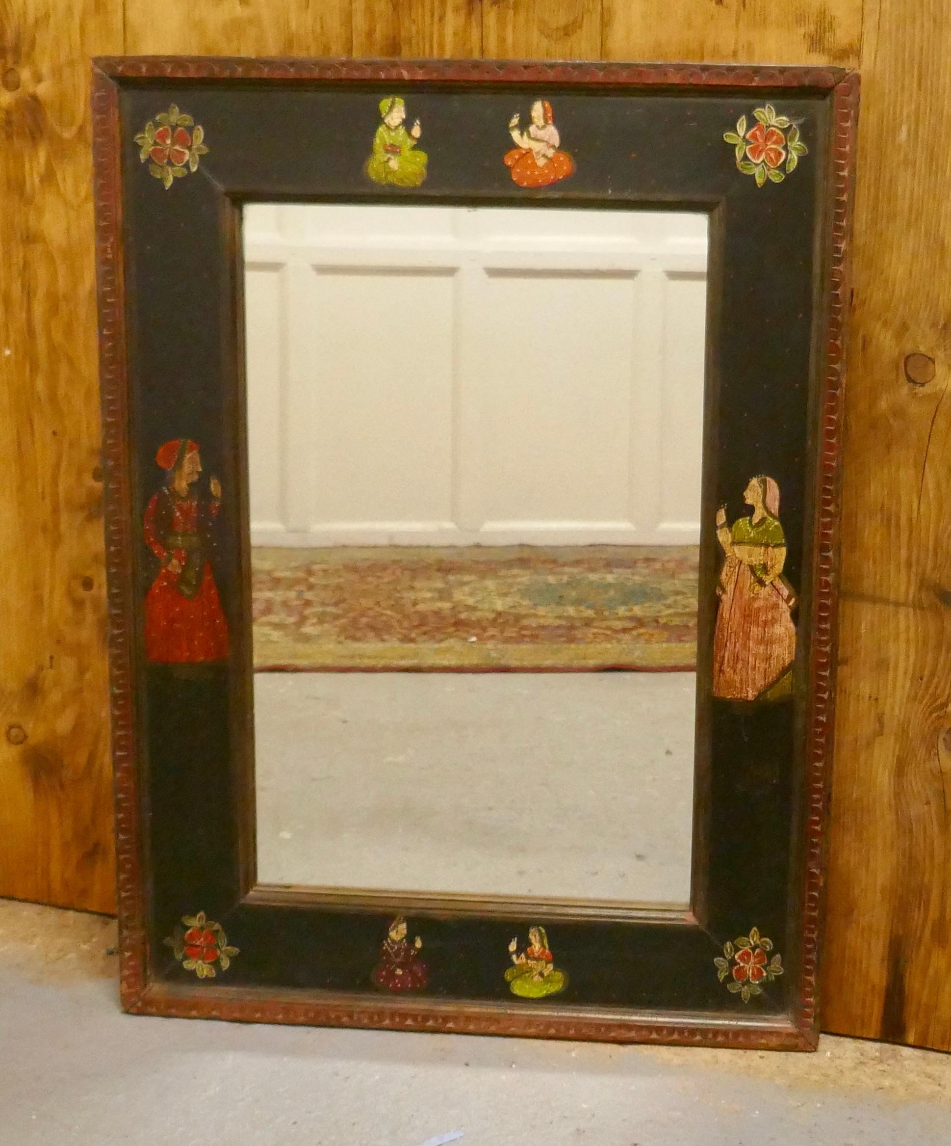 Anglo-Indian Folk Art painted wall mirror 

 The mirror frame is 4.5” wide it has a carved edge and it is decoratively hand painted, the primitive folk art depicts flowers and characters from India
The glass is new so this in good condition, the
