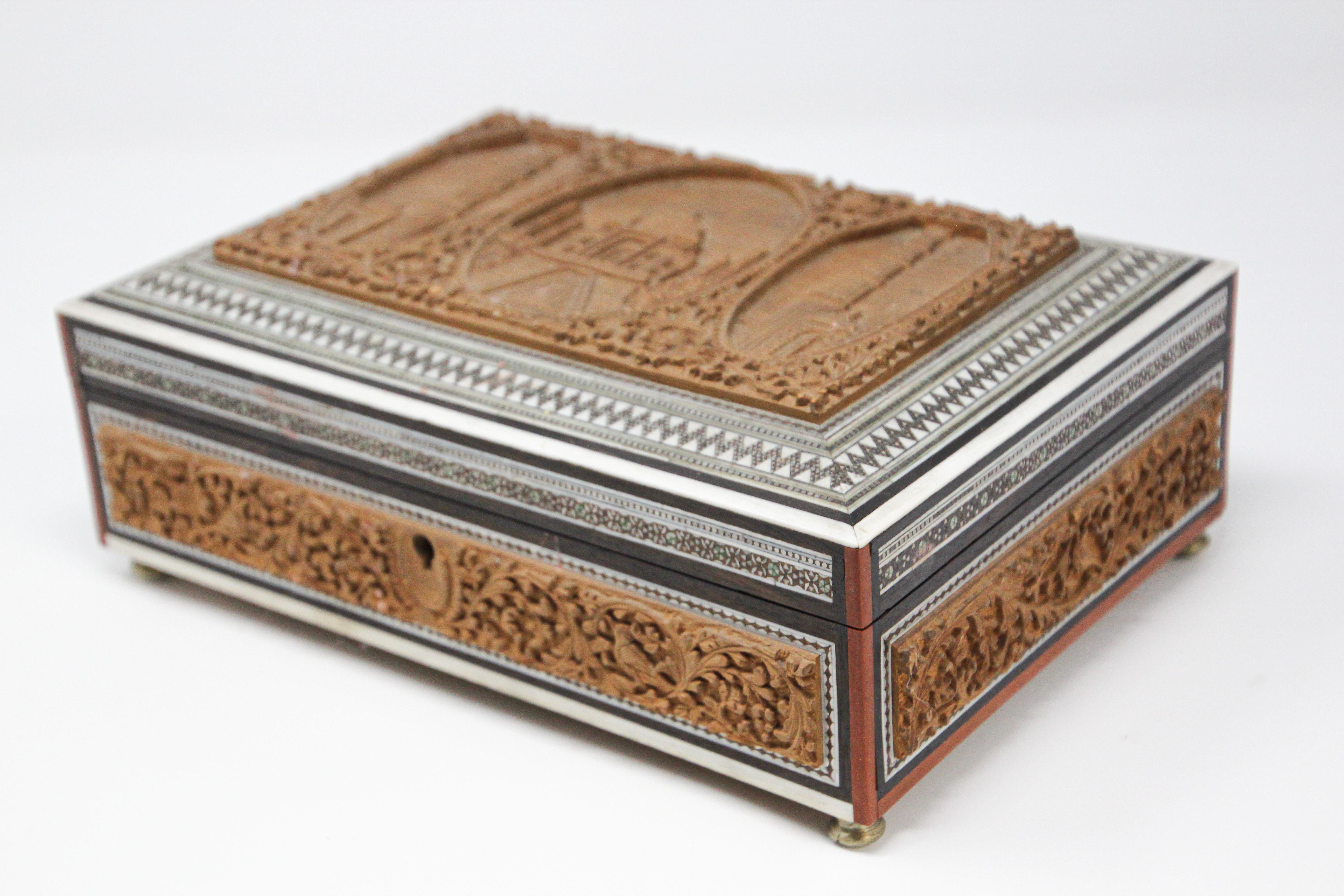 19th century Anglo-Indian wooden box fitted with various compartments finely hand carved.
The top is finely hand carved with the Taj Mahal.
The interior with removable hand carved nine-lidded compartments, the front cover has a mirror, the whole