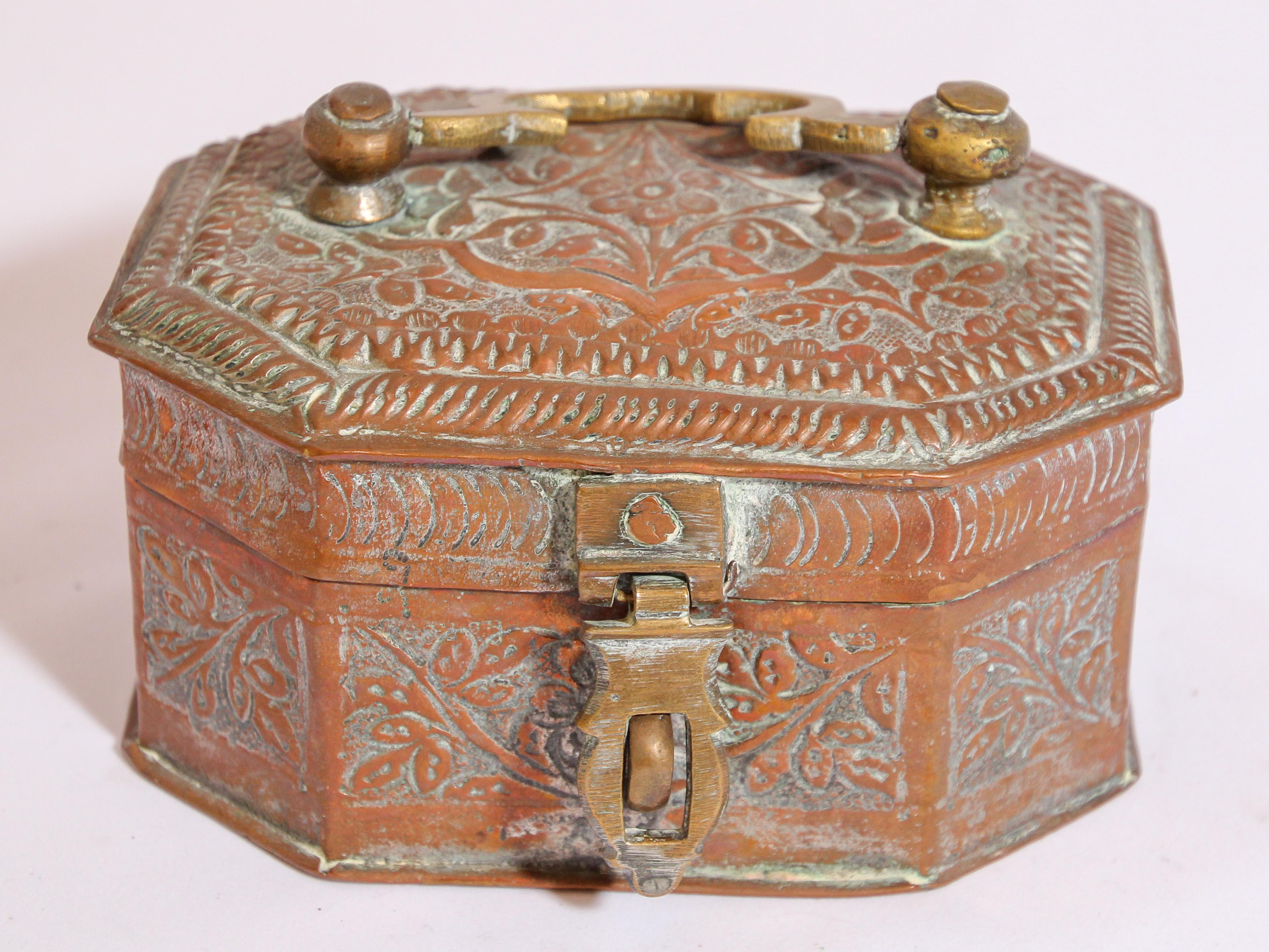 Beautiful handcrafted antique tinned copper decorative octagonal betel box with with lid, handle and brass latch.
The metal is delicately and intricately hand-hammered and repousse with floral and geometric designs.
This Vintage brass box is a Paan