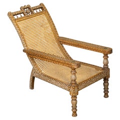 Used Anglo-Indian Inlaid Plantation Chair with Scrolling Foliage and Extending Arms