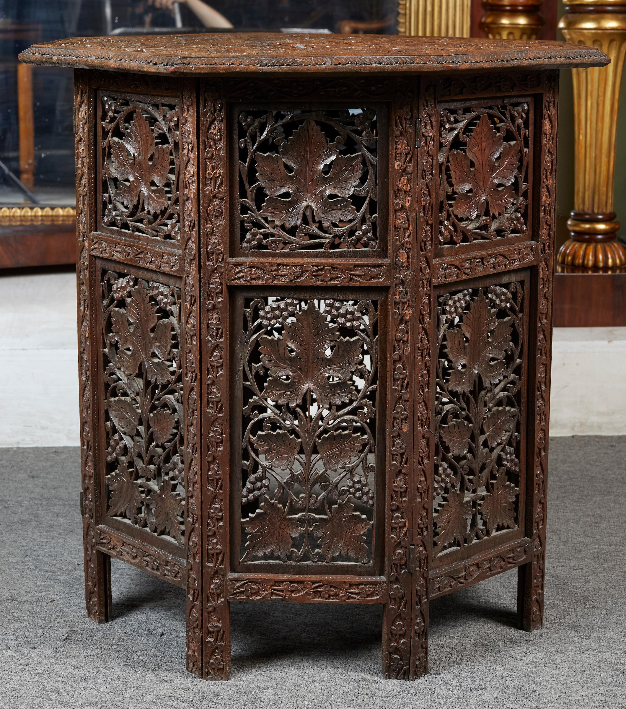 Anglo Indian intricately carved teak octoganal folding side table with grape work by Indo-Foreign Commercial Co.