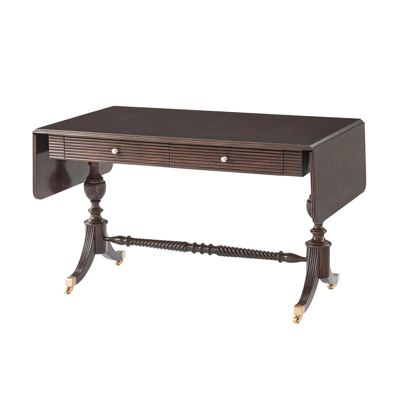 Inspired by the 19th Century age of exploration, this Regency Anglo Indian Style reeded-edge drop-leaf mahogany sofa table doubles as a writing table. The top is set on turned, reeded and spiral-carved balusters with down-swept legs, terminating in