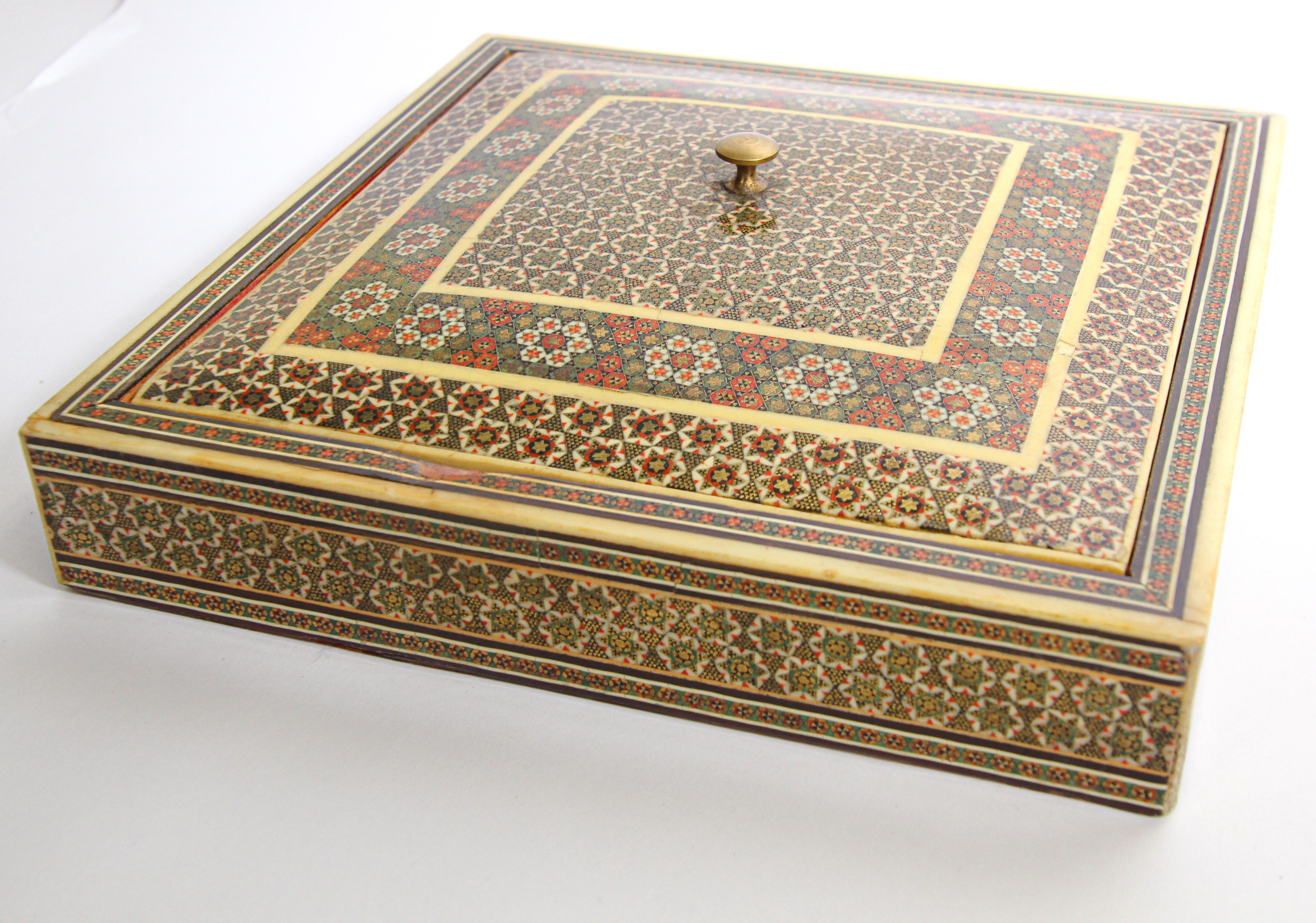 Indo Persian Moorish style micro mosaic inlaid jewelry box with lid.
Intricate inlaid Anglo Indian box with floral and geometric Islamic
Moorish Sadeli design in a square shape form inlay in mosaic marquetry, very fine artwork, lined in red