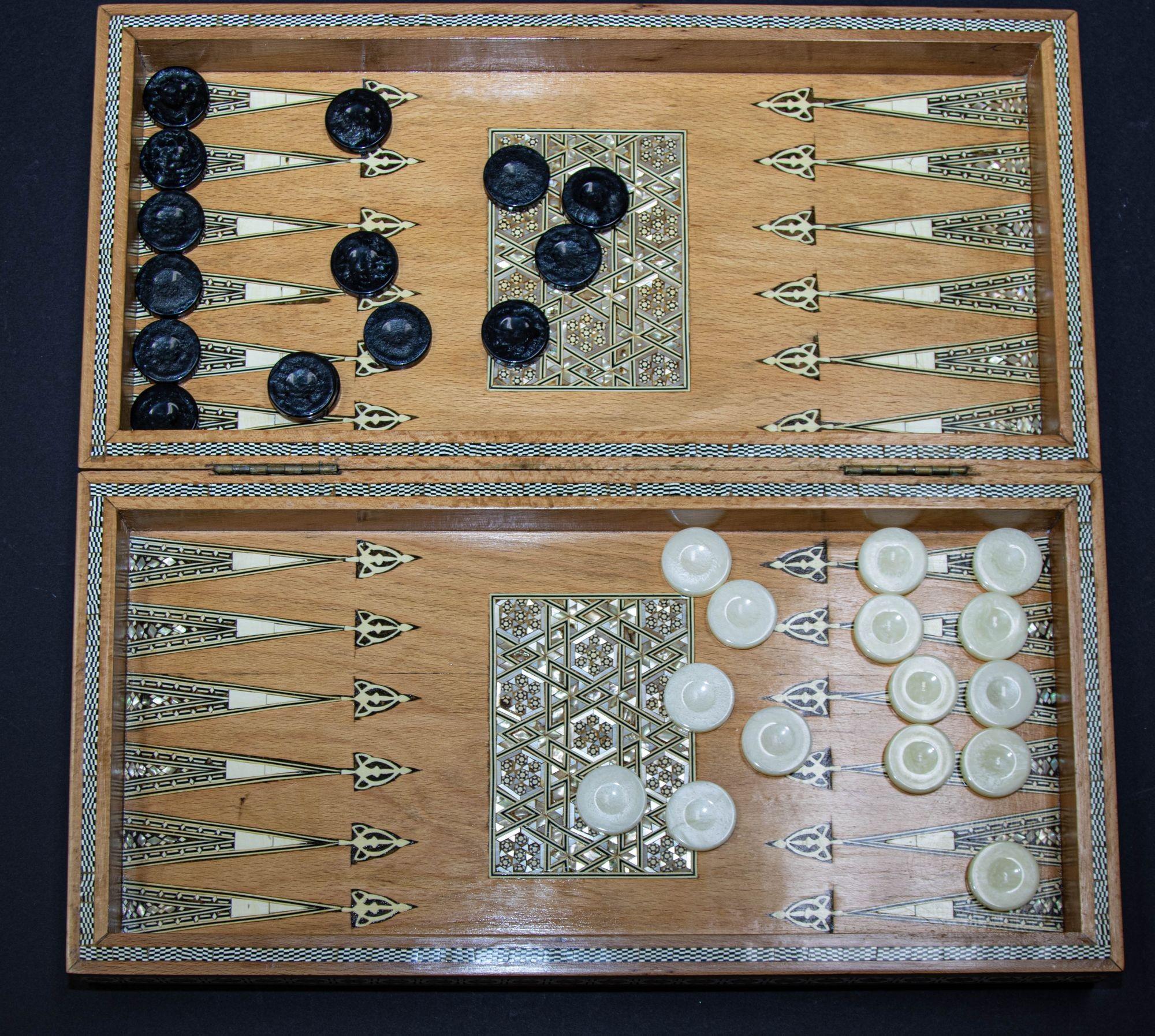 Anglo Indian Mother-of-Pearl inlaid Backgammon and Chess, Checker Box complete with game pieces.
A large and rare Anglo Indian checker, chess and backgammon box, with a hinged lid that opens to a checker or chess board on the top, and a backgammon