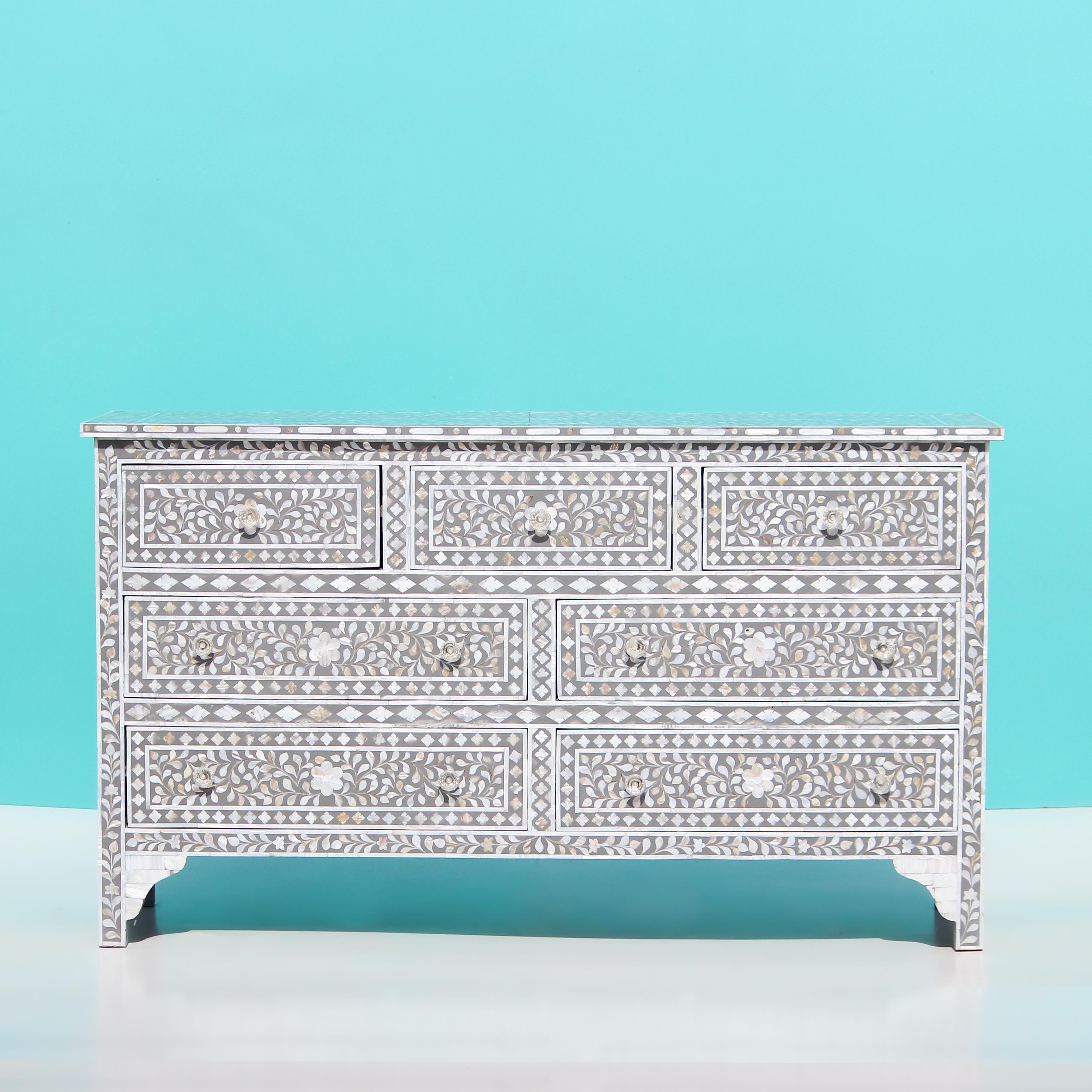 Introducing our exquisite Mother of Pearl Dresser, handmade with the finest small mother-of-pearl pieces through the age-old technique of inlay furniture making. This piece is reminiscent of the Bone inlay process and exudes a timeless quality