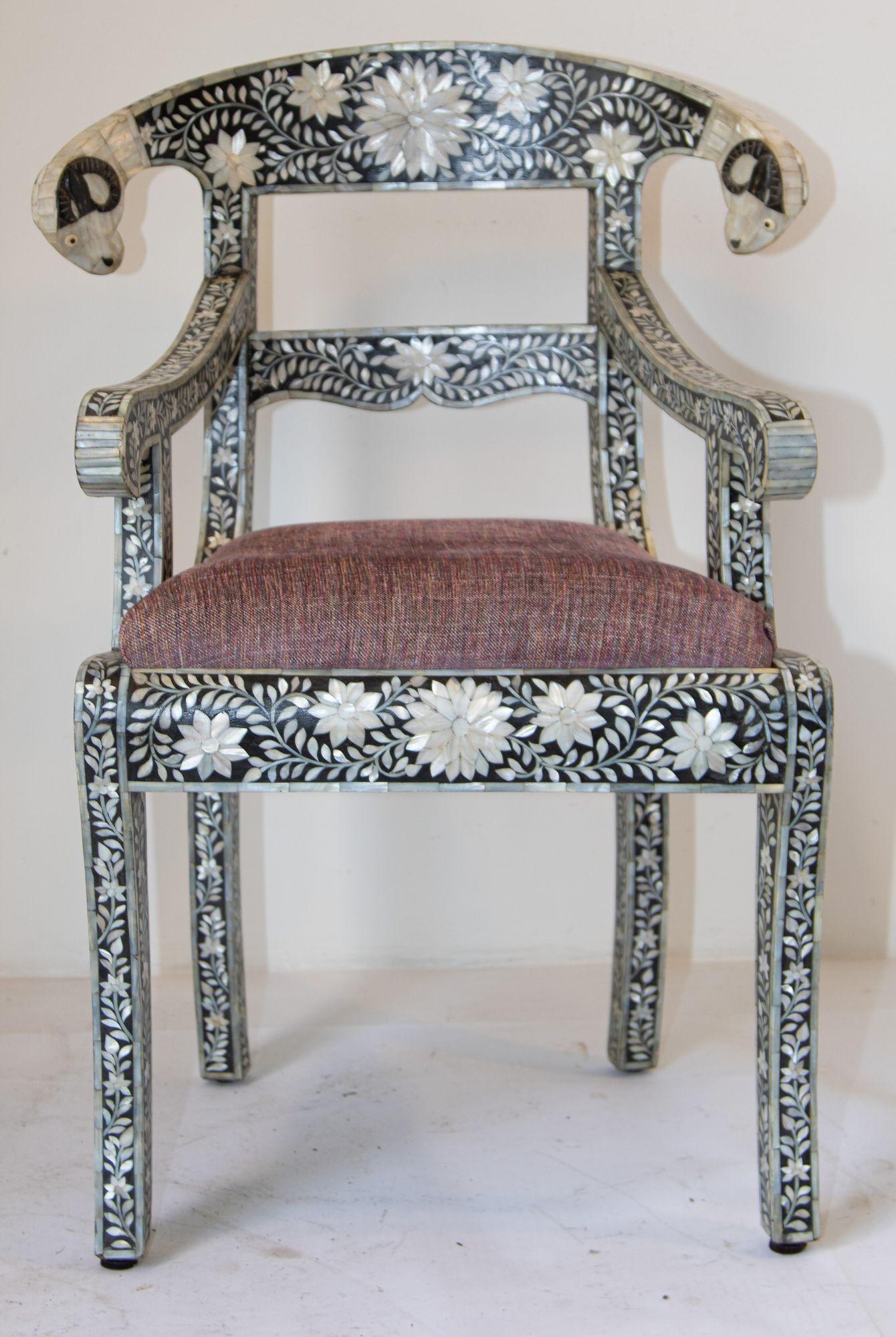 Anglo-Indian Mughal Mother of Pearl Inlaid Klismos Armchair with Ram Head. 1 of 2 available.
Anglo-Indian Mughal black and white mother of pearl inlaid armchair with ram's head.
Mother-of-pearl klismos style armchair with ram head detail.
This