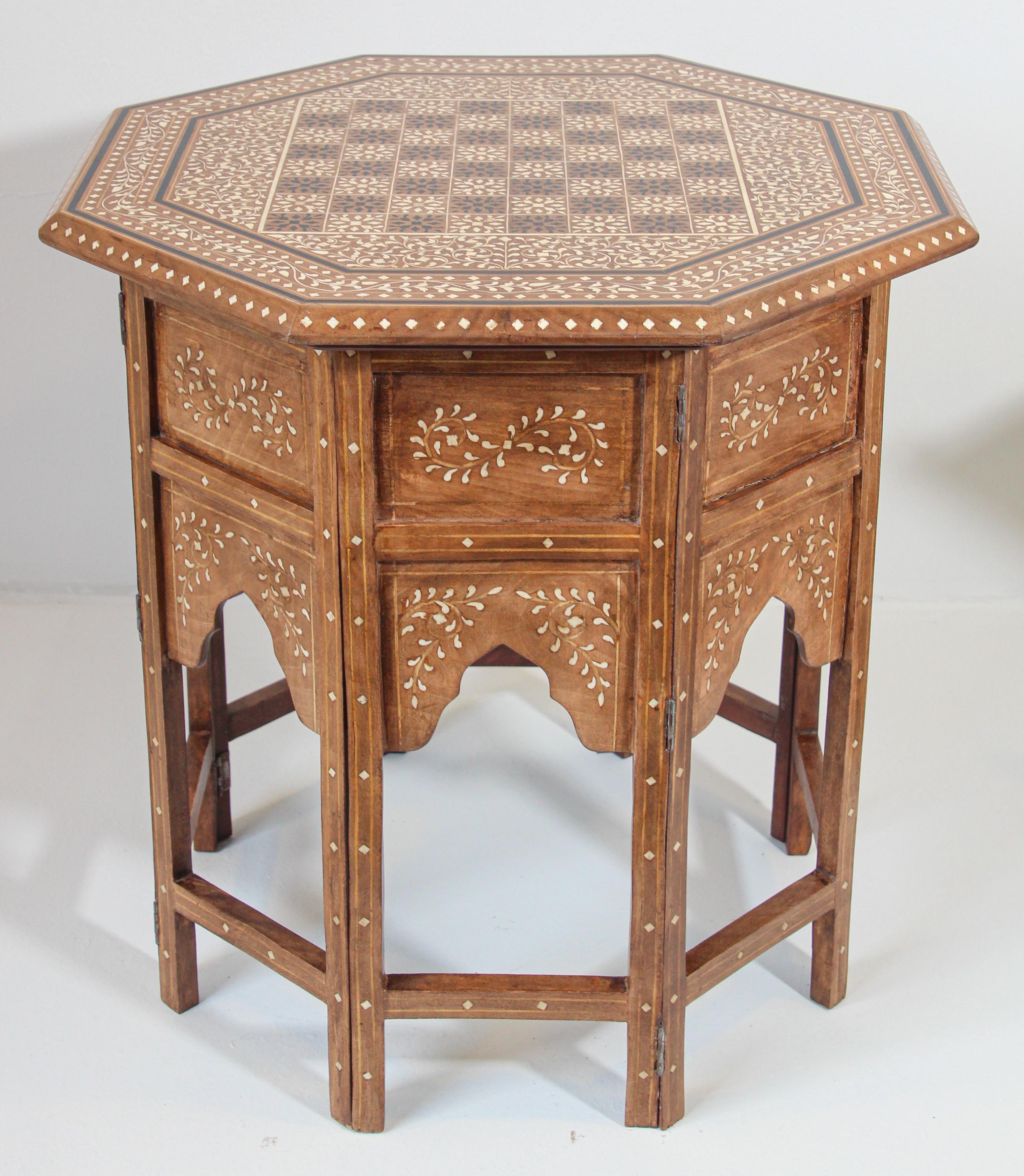 Anglo-Indian octagonal Mughal Moorish chess game table with bone inlay.
Vintage fine and elegant Anglo Indian folding Moorish Mughal teak octagonal open arches side table.
Large Anglo-Indian wood end table finely carved and inlaid with the top
