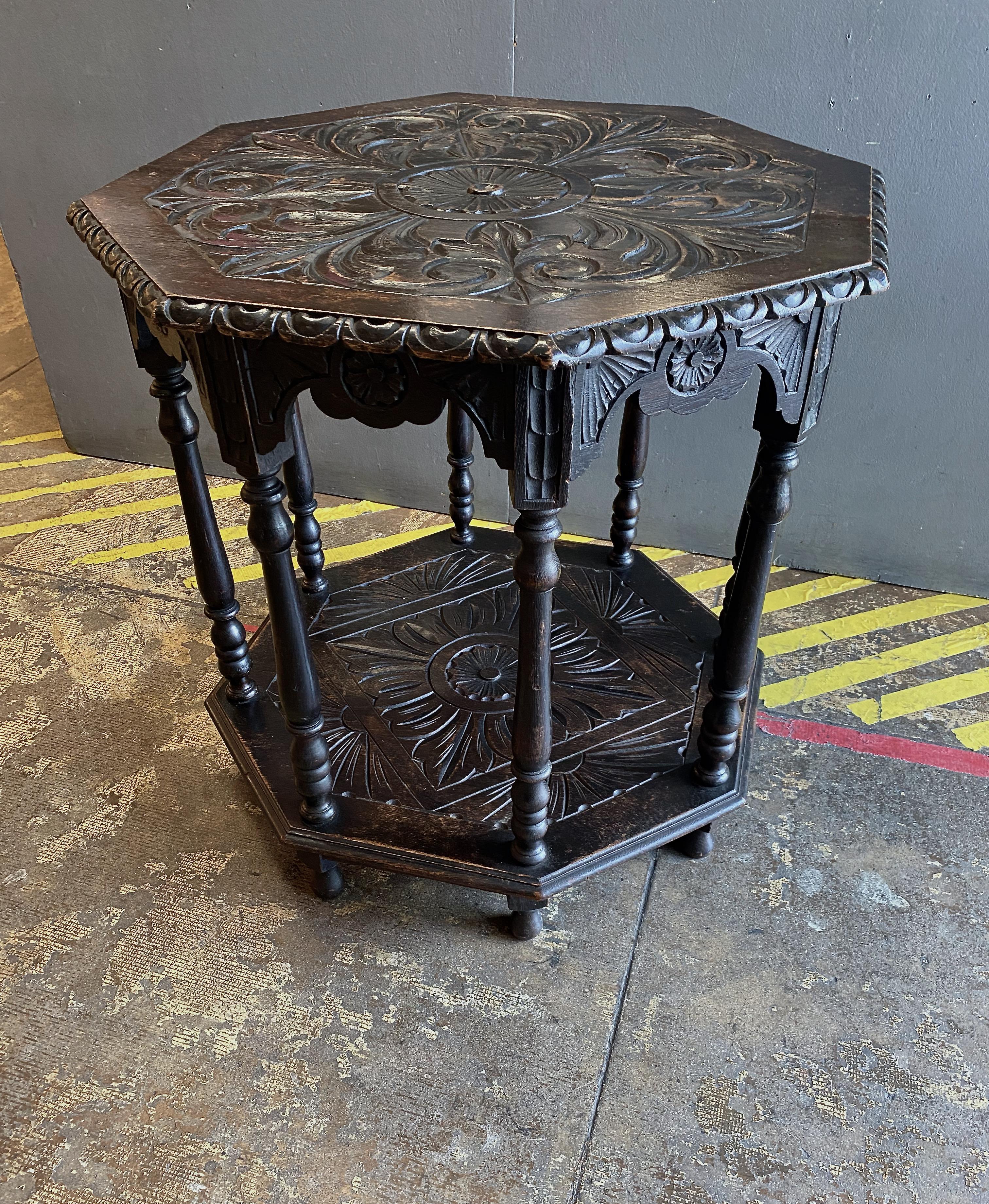 This is a very good example of an early 20th century Anglo Raj center or side table. The table is well carved in traditional Indian scrolling motifs to the top and more abstract geometric forms on the lower shelf. The table is in overall very good