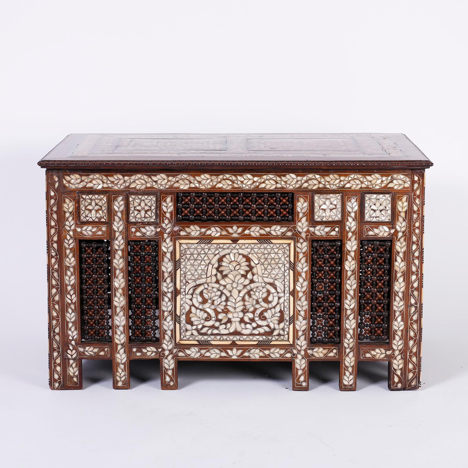 Refined antique Anglo-Indian or Syrian coffee or occasional table with a rectangular top inlaid with mother of pearl in a symbolic floral design. The base is decorated on four sides with elaborate mother of pearl inlays, stick and ball panels and