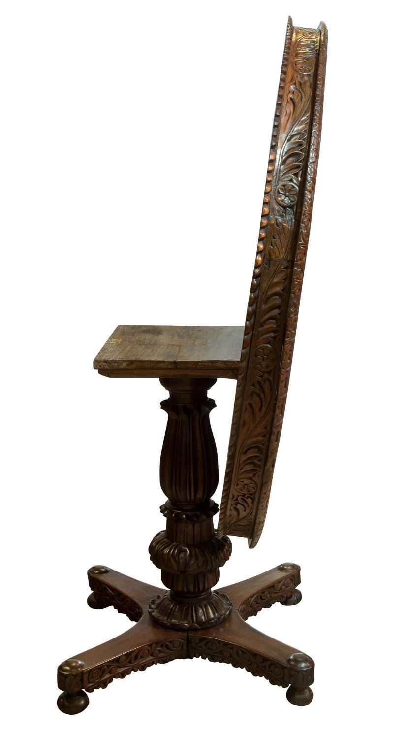 An Anglo Indian padauk wood centre table with carved frieze to tip-up top and base,

circa 1880.