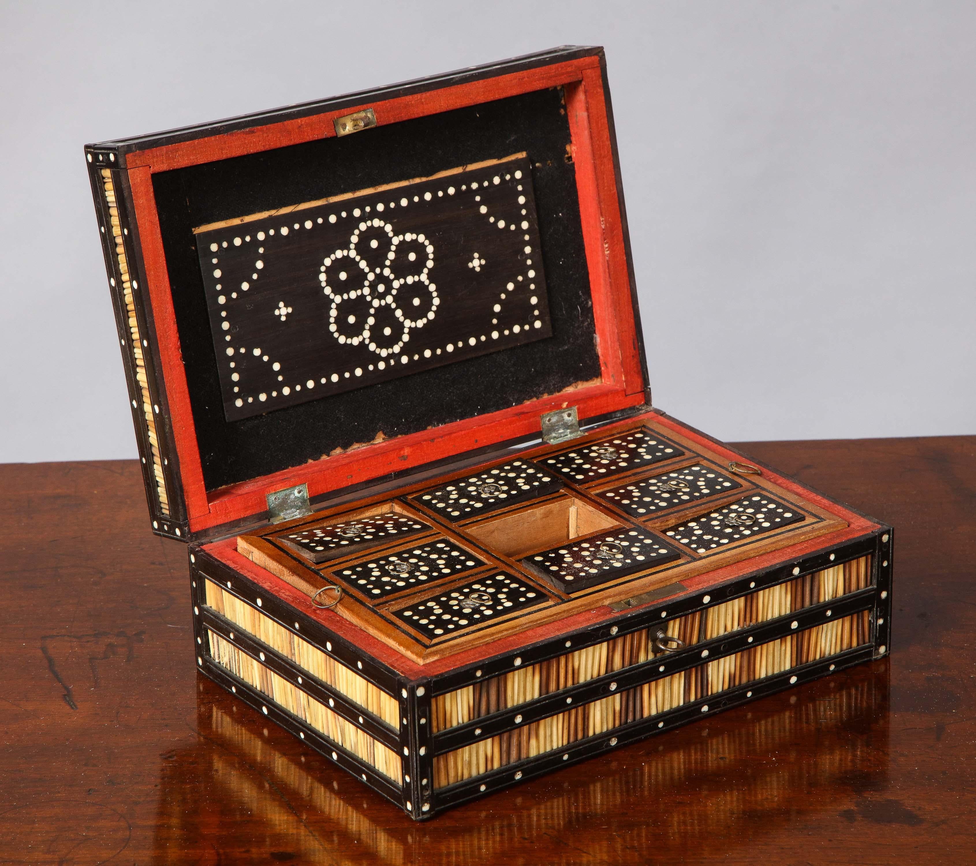 Good mid-19th century porcupine quill decorated box, having bands of striated quills between bone inlaid ebony stiles, the interior with lift out tray with nine compartments having fitted lids, the whole with good patina and having especially well