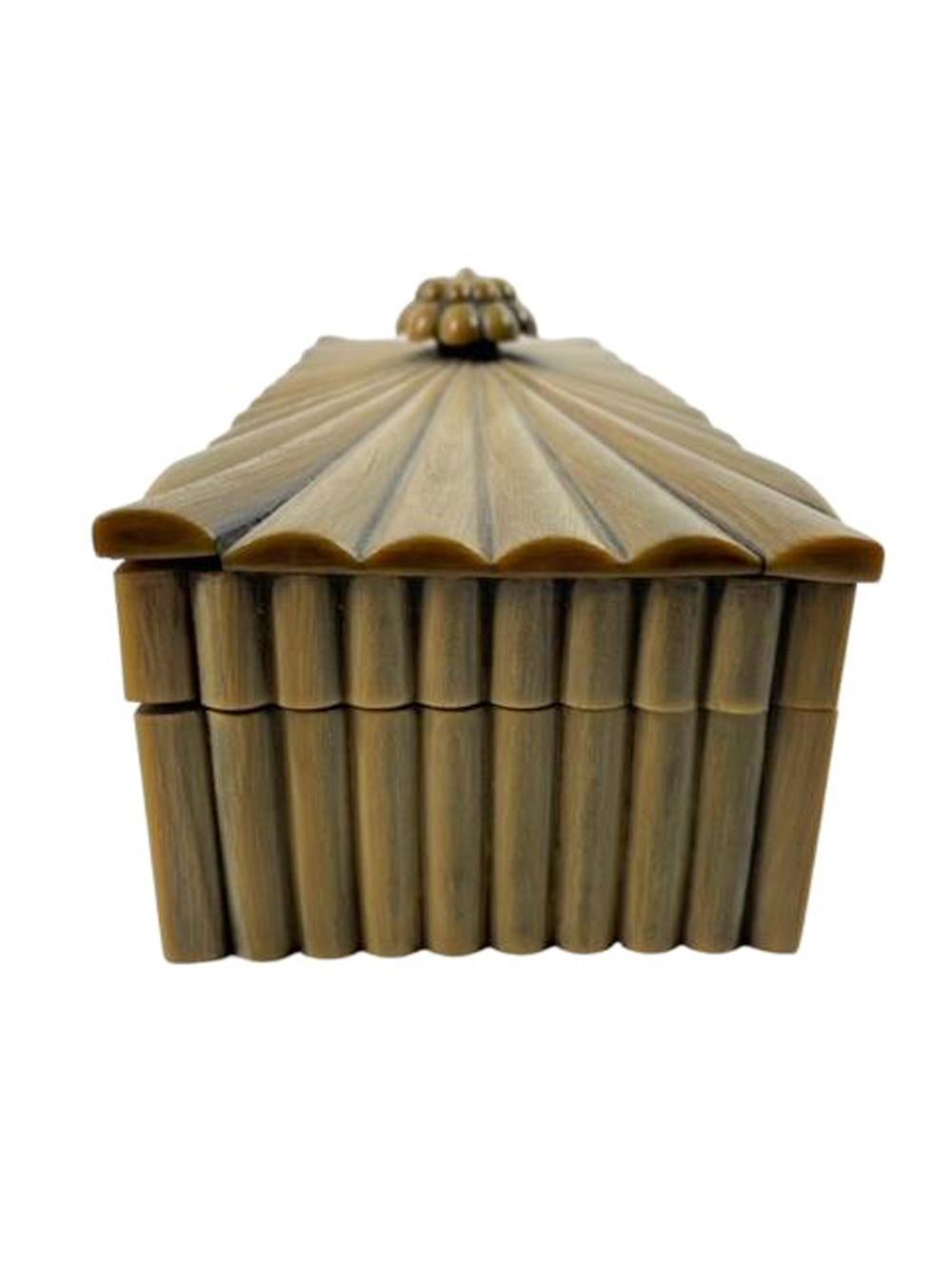 Anglo-Indian glove or trinket box from Vizagapatam of rectangular form with sloped top. Made from sandalwood with vertically ribbed horn veneered sides and starburst ribbed lid with central carved horn finial knob of lotus bud form. The horn of a