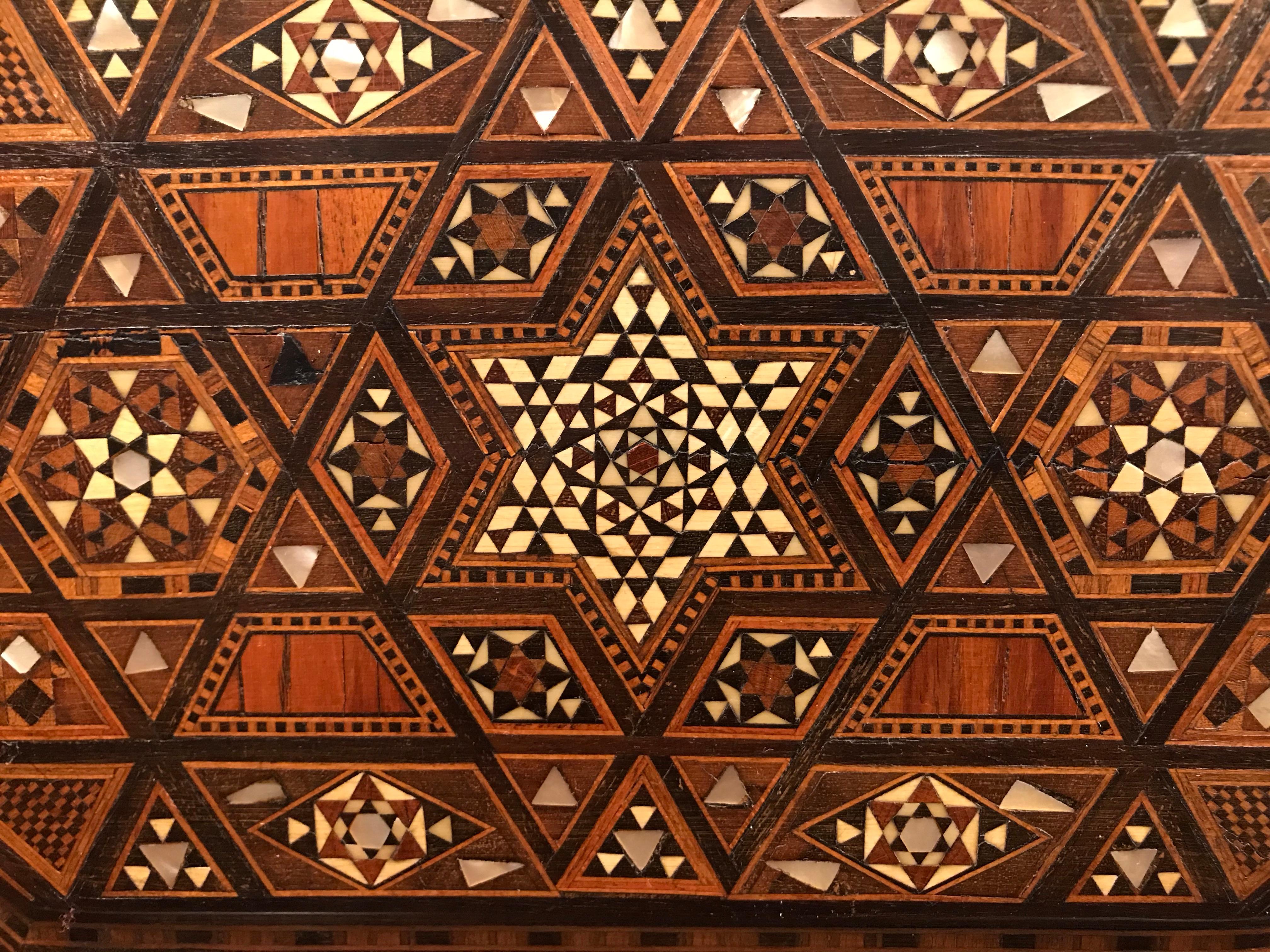 A beautifully designed Moroccan box with the surface completely inlaid with tropical woods, such as rosewood and ebony, polished bone and mother of pearl. I'm always astounded by the intricate workmanship of these boxes. The interior of the lid is