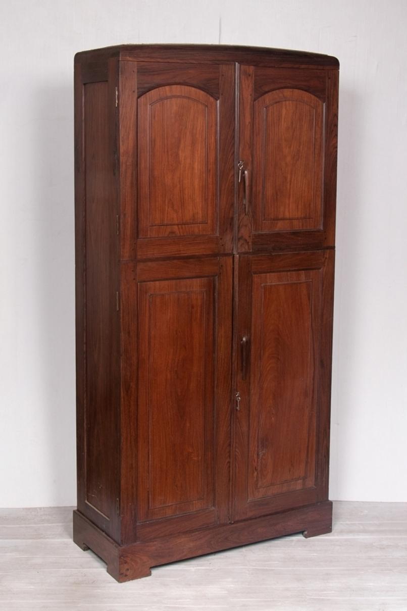 An Anglo Indian four doored cabinet made in rosewood with internal shelving from Kerala.