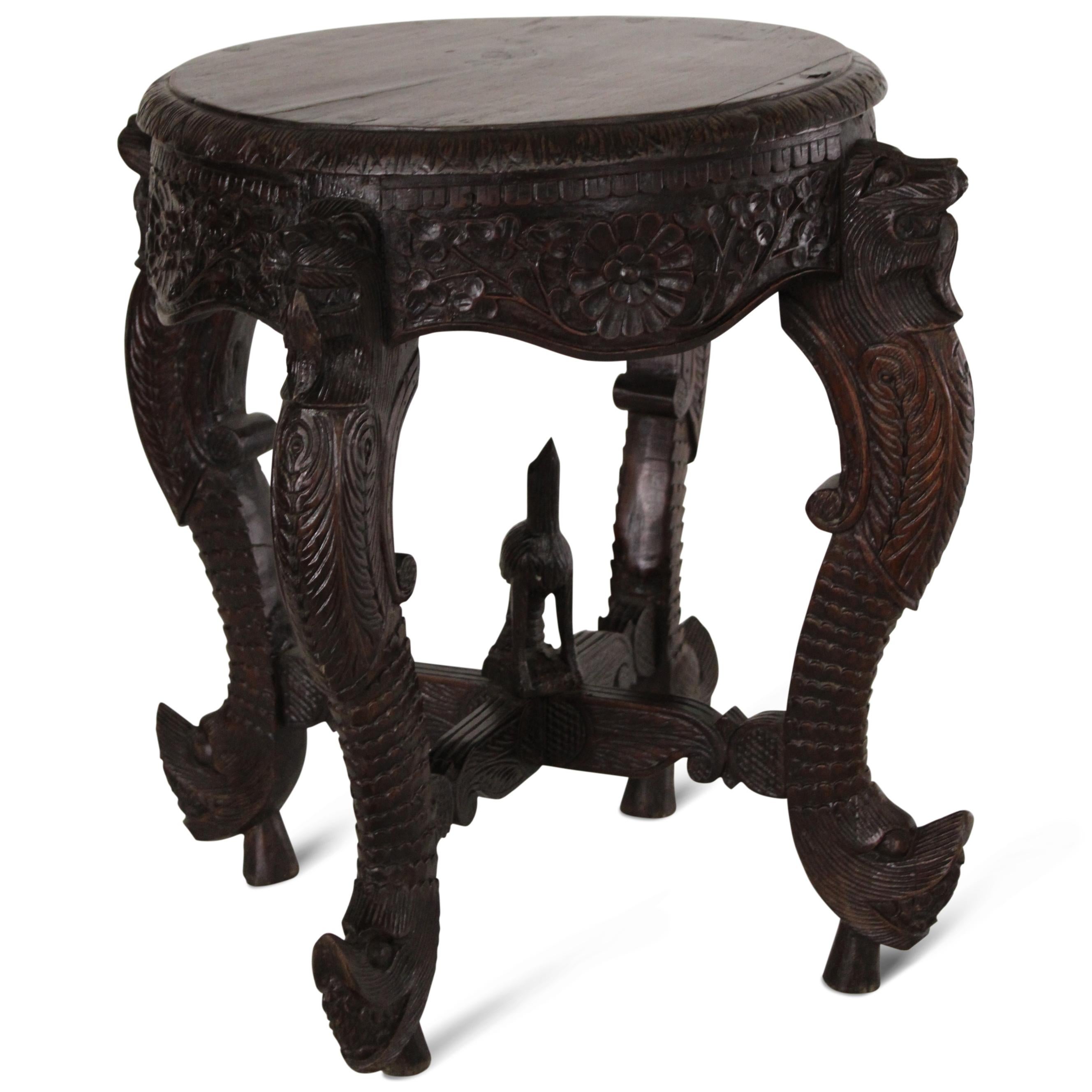 
An early 19th-century Anglo-Indian rosewood teapoy of fine craftsmanship, featuring intricate carved details throughout. It retains its original polish, along with a rich patina. The teapoy stands on lion's face-carved feet that transition into