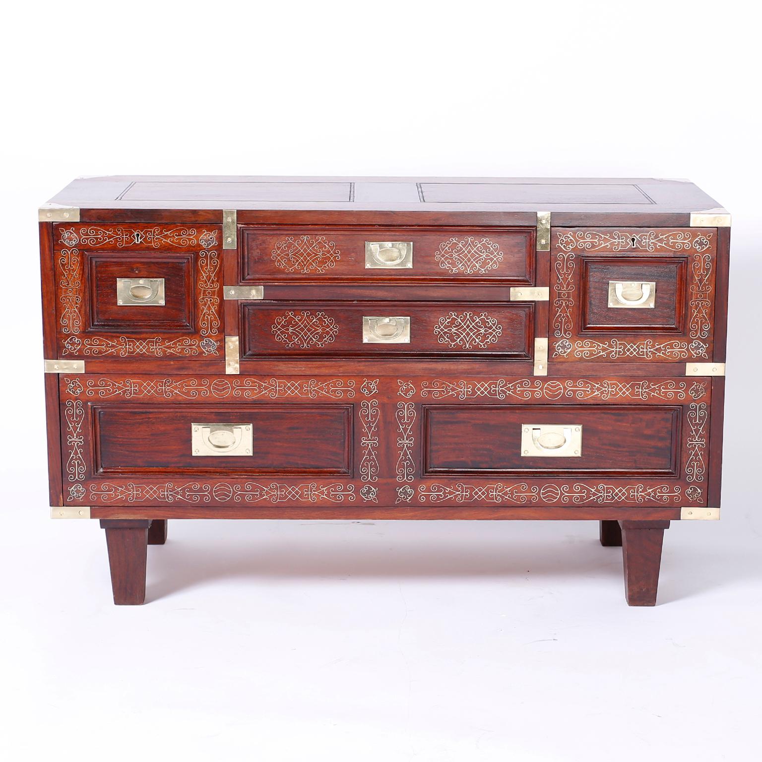 Anglo Indian chest expertly crafted in rosewood featuring floral brass string inlays on the top, draw fronts, and sides, campaign hardware and tapered legs. As seen in the last photo of the listing, a similar chest is available, making a near pair.