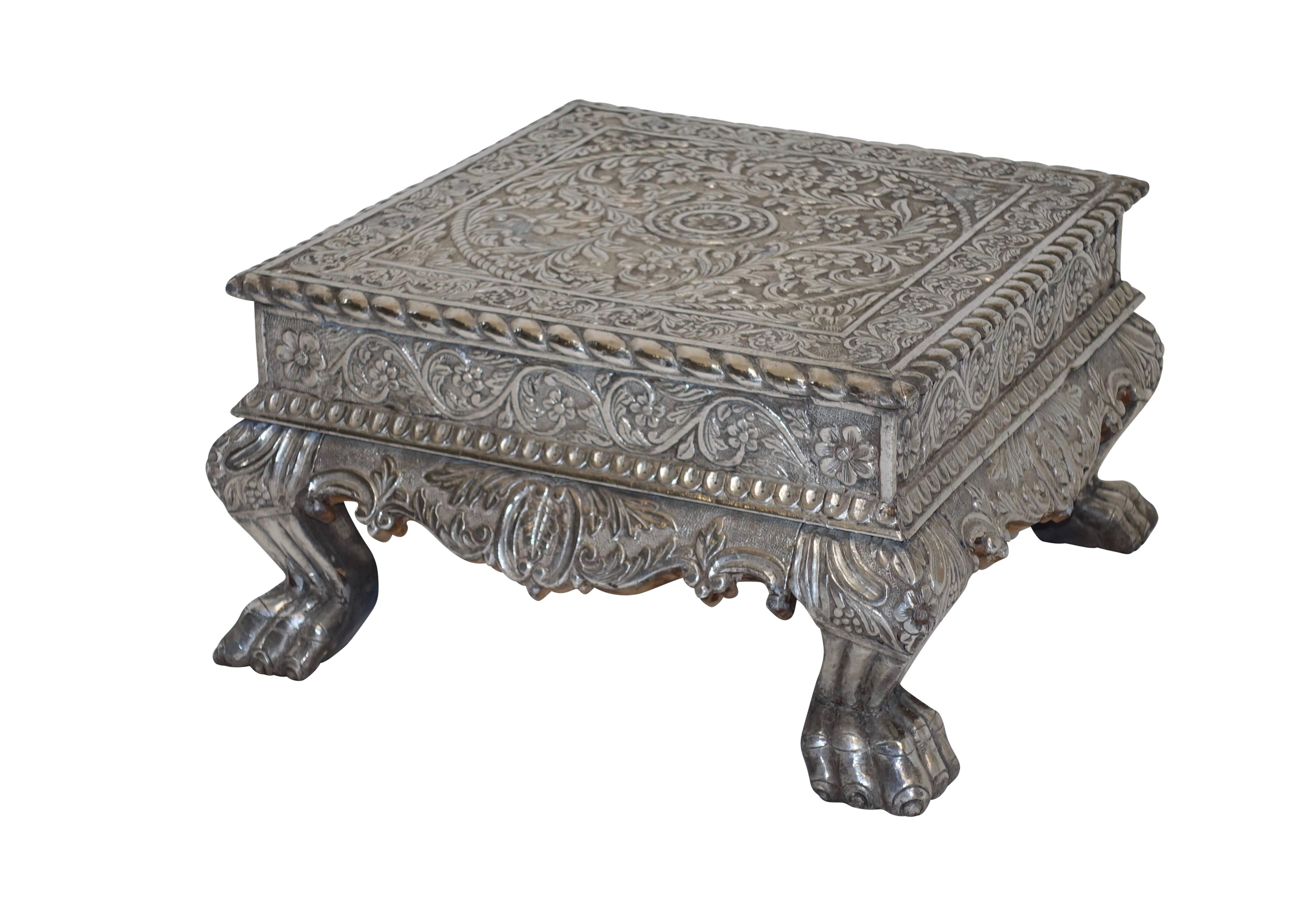 Silver clad and intricately carved teak wood Bajot or low table. These tables were traditionally used for eating or ceremonial offerings,
India, circa 1925.