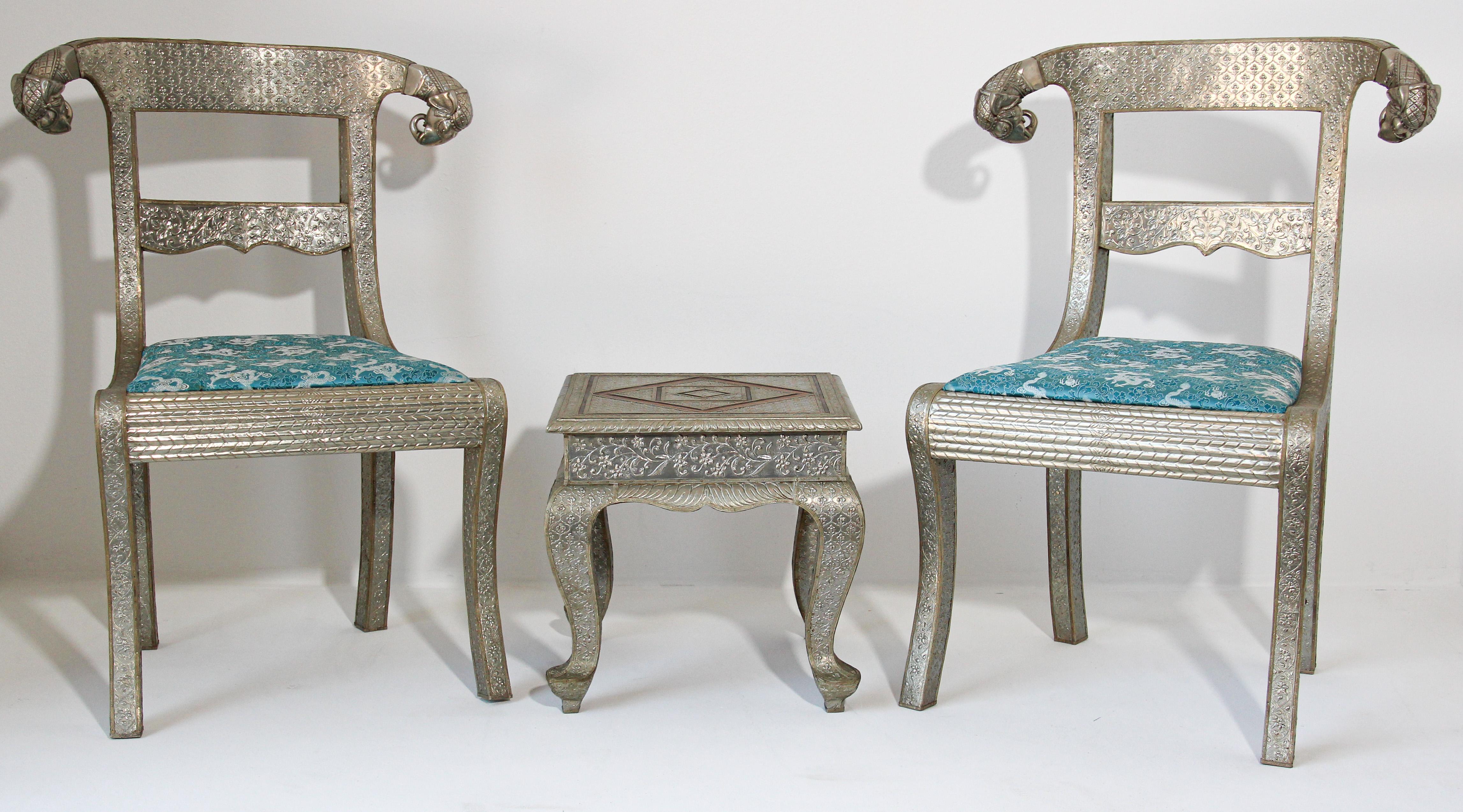 Set of Anglo-Indian silvered wrapped clad side chairs and table.
Anglo Raj wedding palace chair, hand-hammered with repousse silver metal work over wood with carved elephant head finals and blue cushion, very nice and unusual.
Vintage Anglo-Indian
