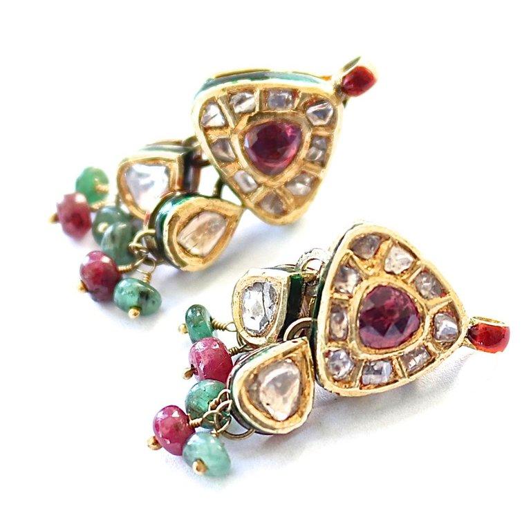 Old world design with colorful old world style. Featuring rose cut rubies and diamonds that are elegantly outlined by magnificent enamel. Crafted in 18k gold.
