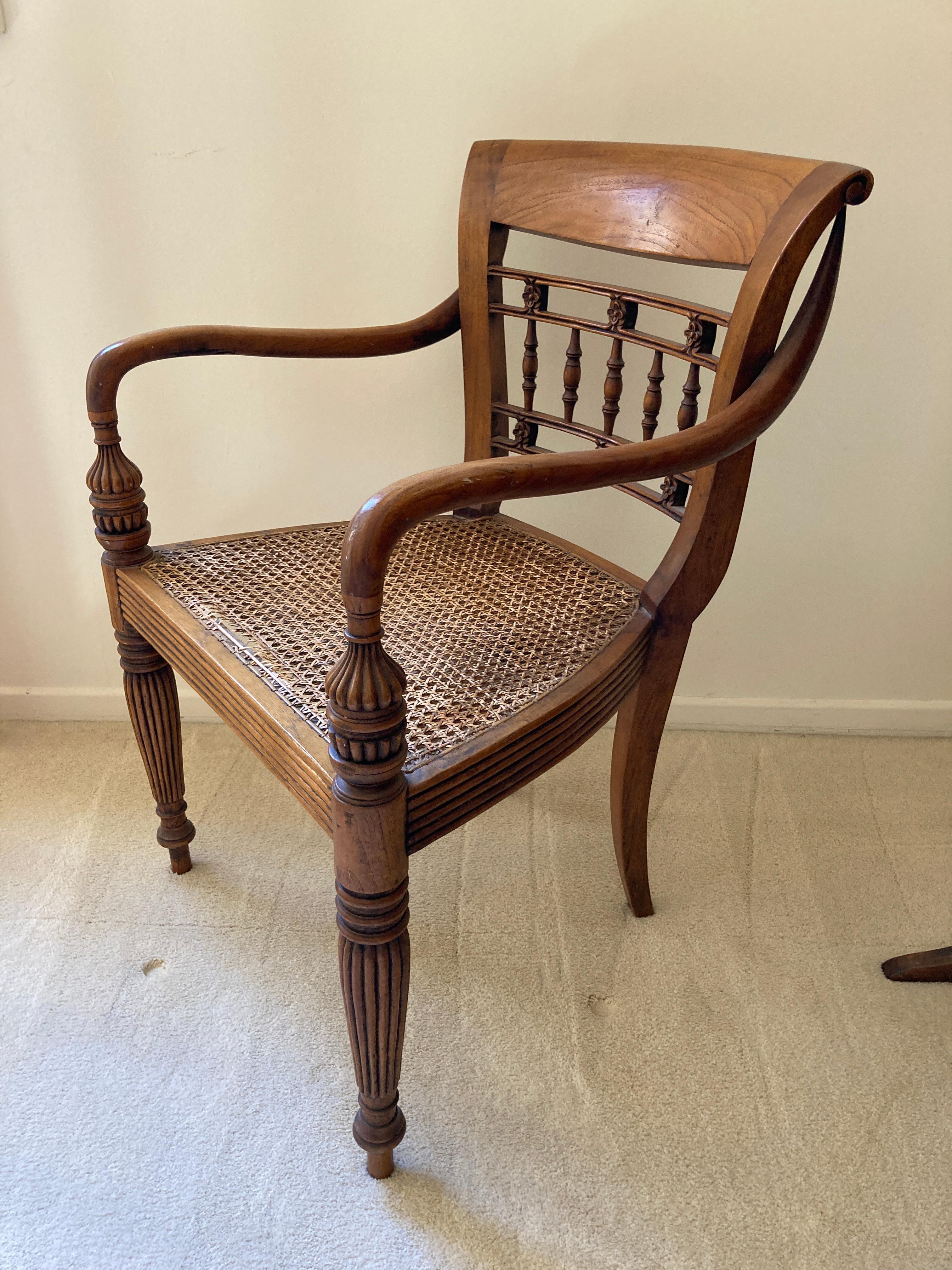 Anglo Indian style library armchairs with turned arms, and cane seat.
Elegant classic armchair with rounded arms raised on carved feet, solid wood construction.
The dimensions are 22