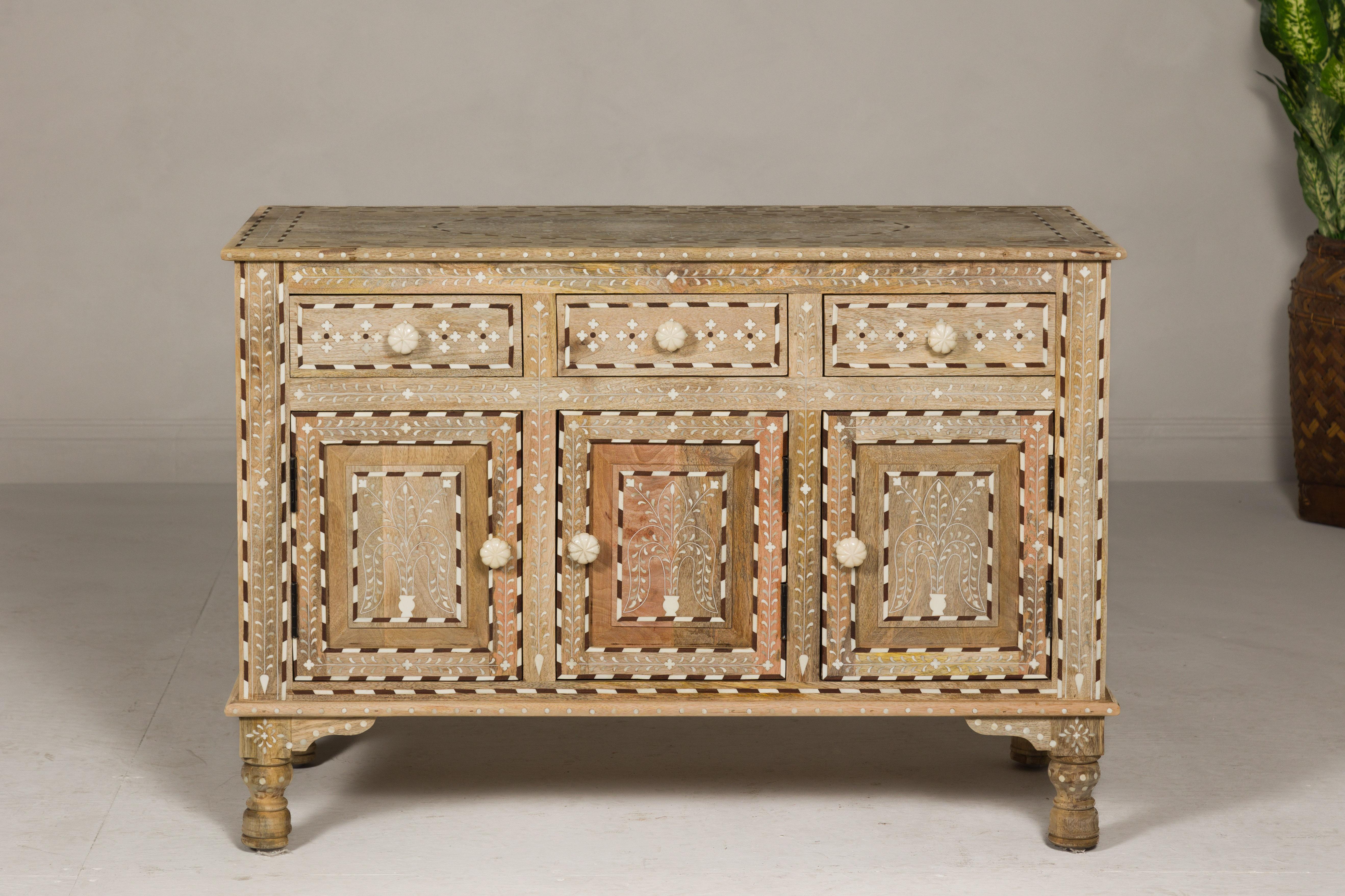 Anglo-Indian style richly inlaid mango wood buffet with three drawers over three doors. Reflecting the opulent heritage of Anglo-Indian style design, this buffet is an emblem of masterful craftsmanship and artistry. Meticulously inlaid with bone,