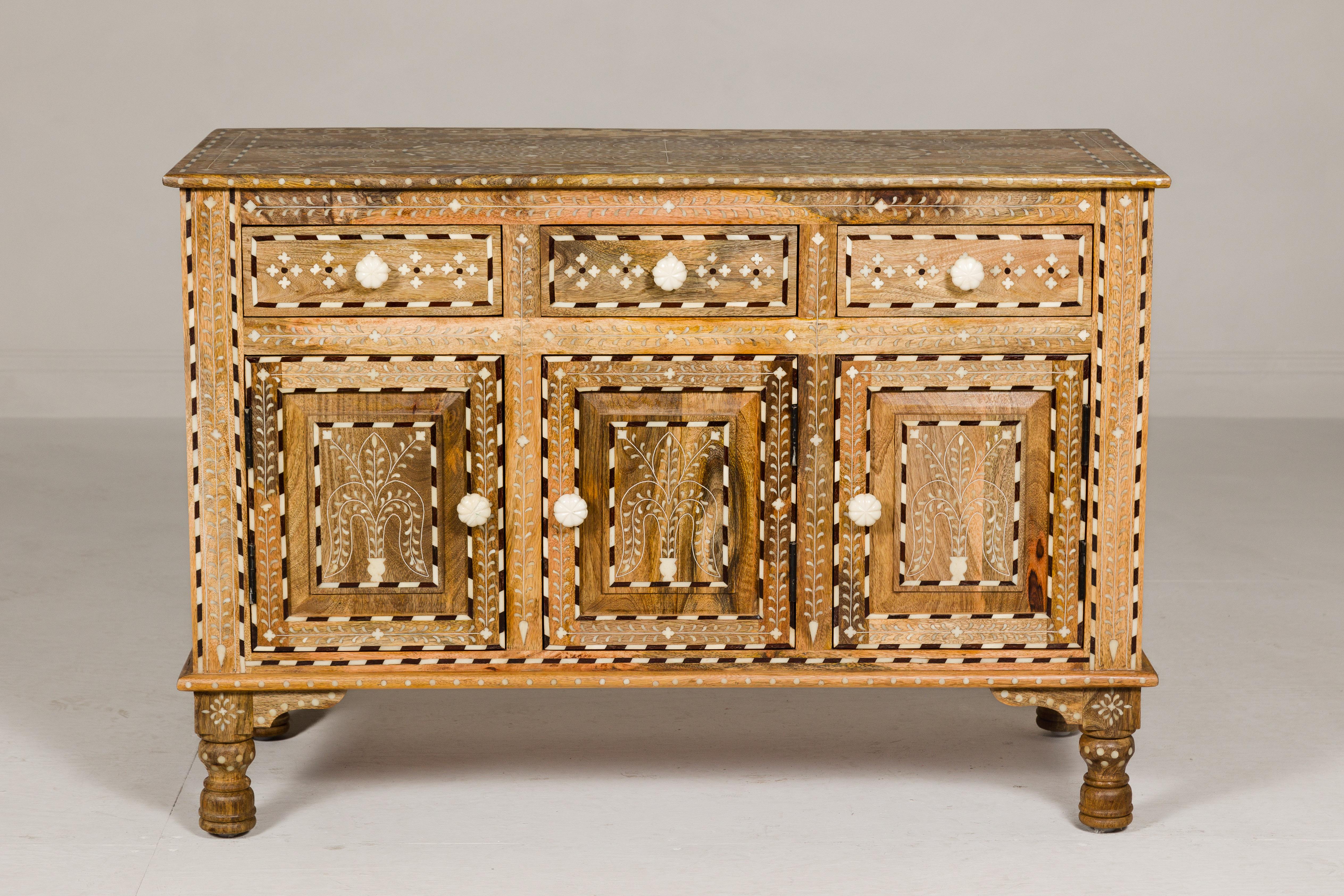 Anglo-Indian style richly inlaid mango wood buffet with three drawers over three doors and dark patina. This Anglo-Indian style mango wood buffet is a true work of art, a testament to exquisite craftsmanship and timeless design. Richly inlaid with