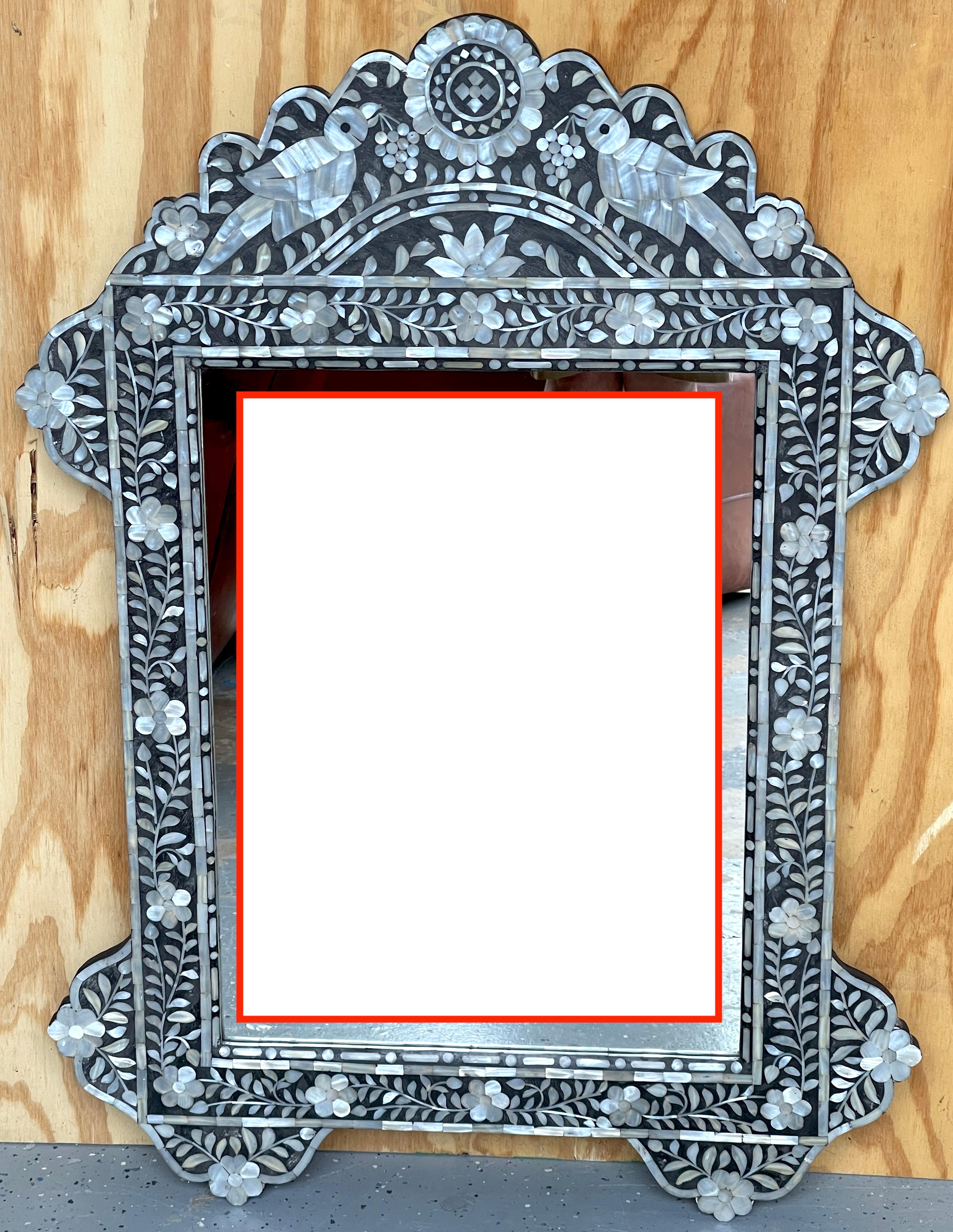 Miroir néoclassique incrusté de nacre de style anglo-indien  
Inde, fin du 20e siècle 

En forme de cartouche rectangulaire, avec incrustations de nacre fine.  avec des oiseaux, des fleurs et des vignes, avec un miroir encastré de 20 pouces de large